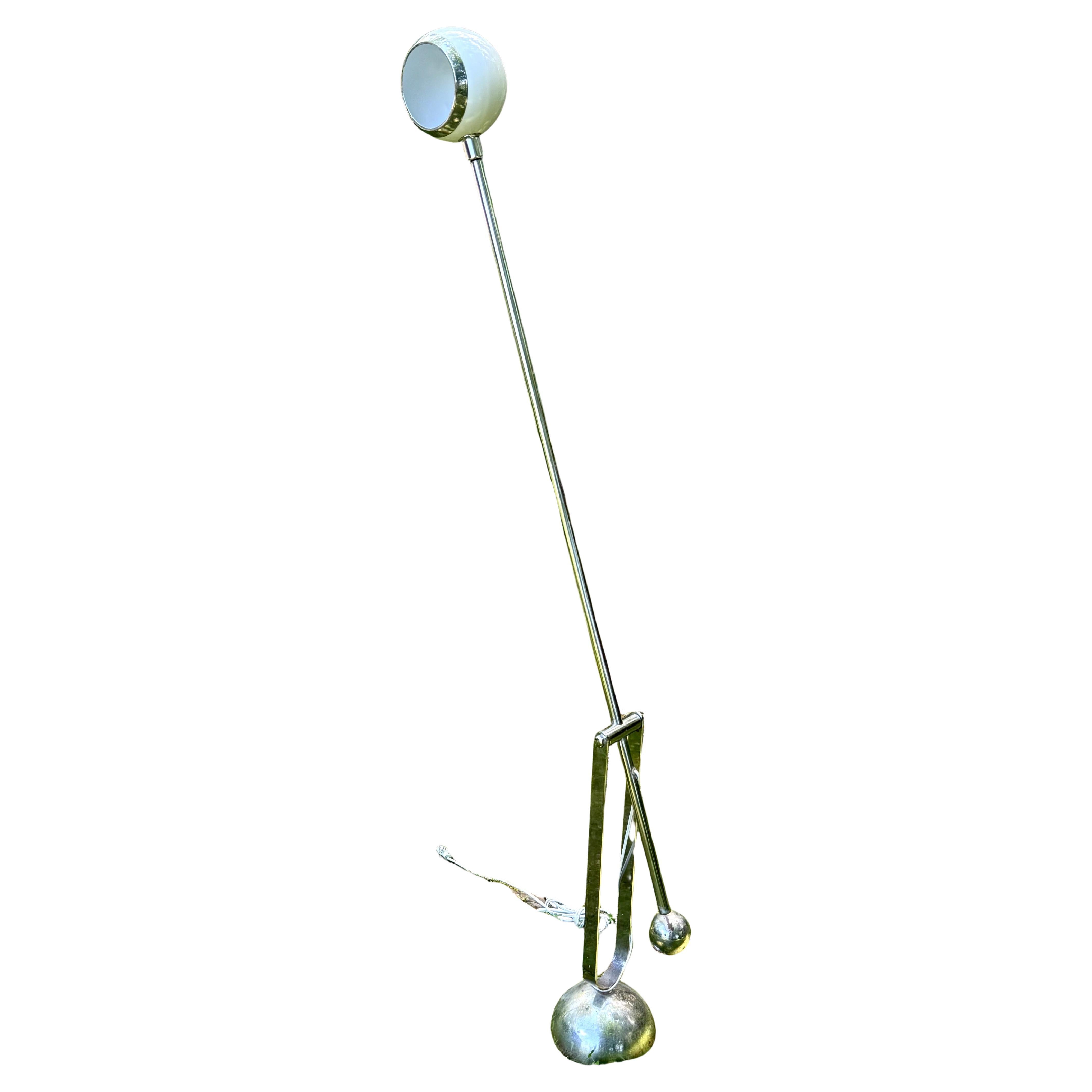 A Rare and Intriguing Italian Midcentury Modern Counter Balance and Cantilevered Floor Lamp in Chrome and White Enameled Metal Attributed to Arteluce, Italy, circa 1965-1970.  The piece combines great diversity of movement and total lighting