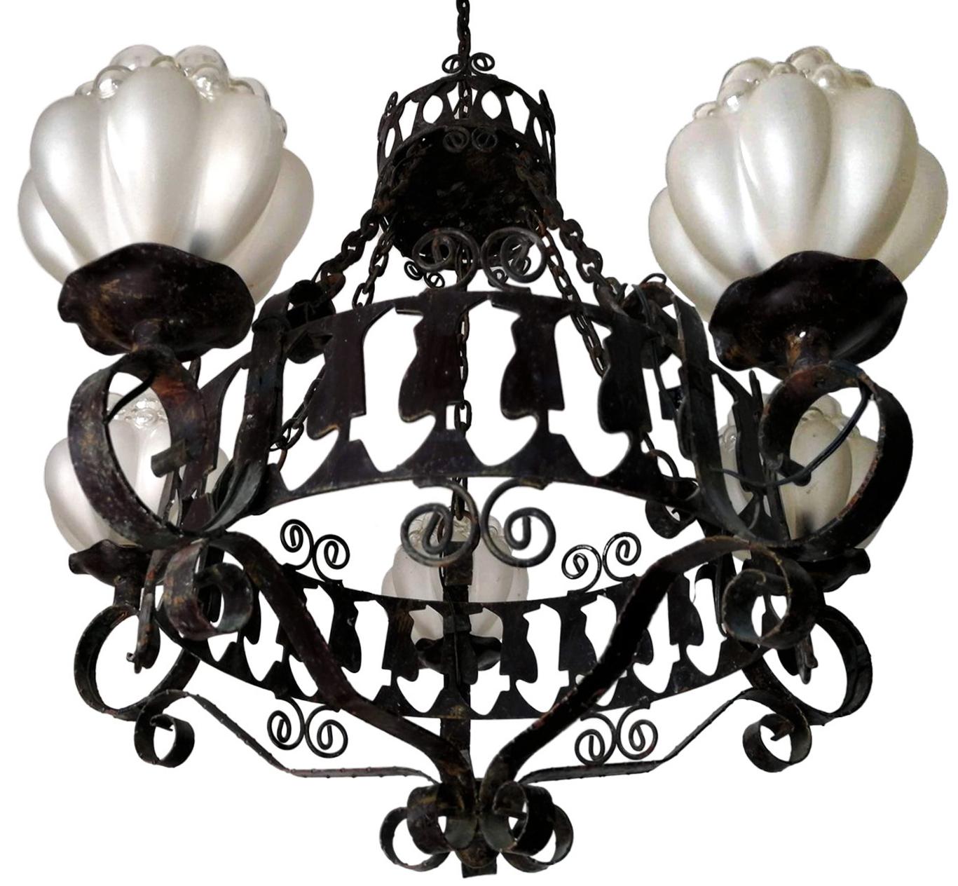 Black Italian fire forged iron chandelier with five hanging light glass globes. Unusual frosted and clear glass globes.
Measures:
Diameter 29.5 in / 75 cm
Height 39.5 in (23.7 in + 15.7 in /chain) / 100 cm (60 cm + 40 cm /chain)
Weight 13 lb. (6