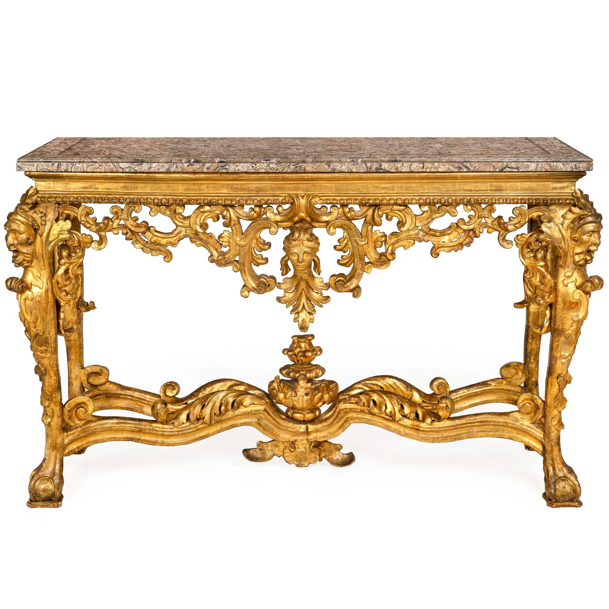 ITALIAN ROCOCO CARVED AND GILTWOOD CONSOLE TABLE DEPICTING THE AMERICAS

Probably Rome, circa 1750  with later fossilized stone top

39 3/8