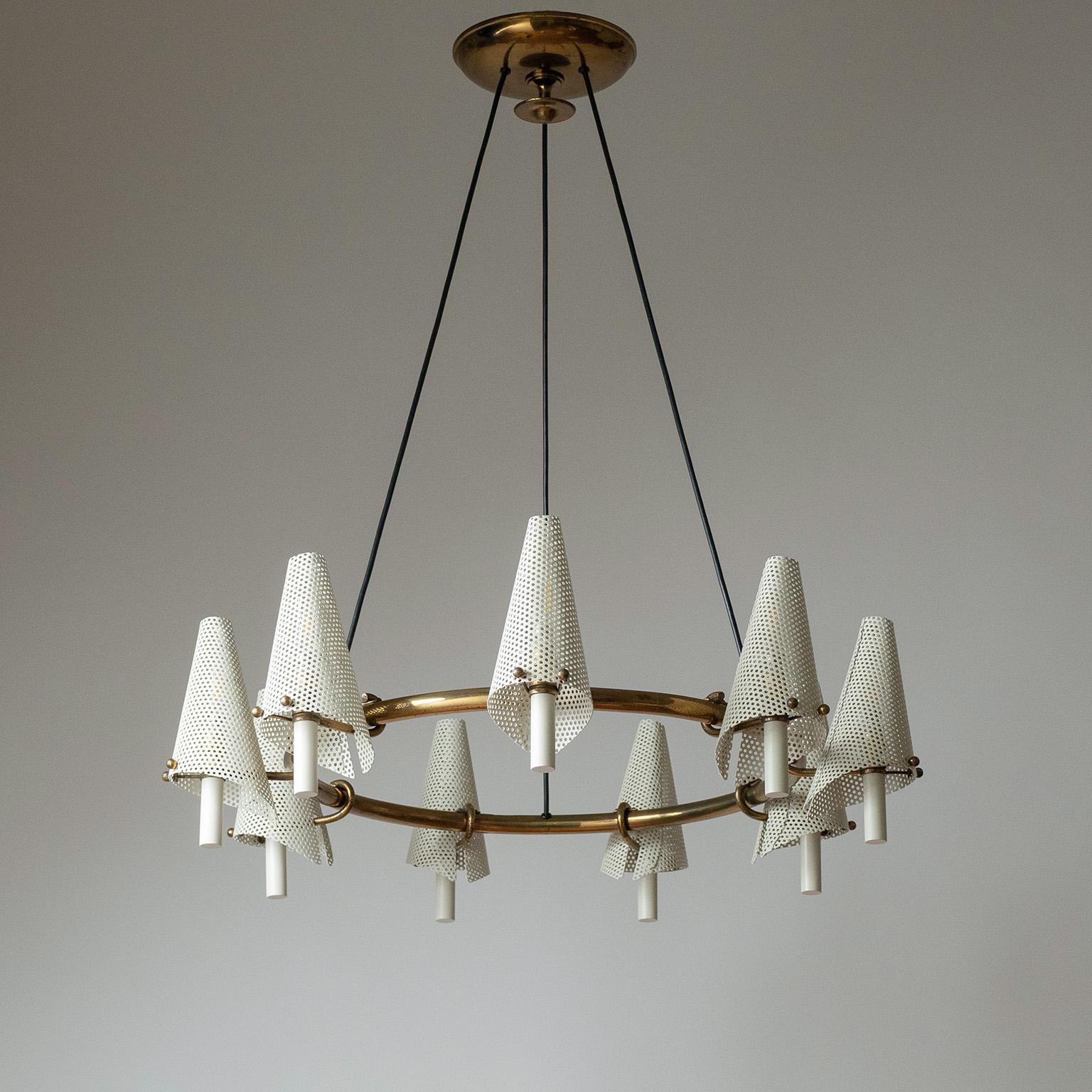 Rare Italian suspension chandelier from the late 1940s to early 1950s. Large brass ring with nine sculptural sconce-like arms with perforated steel shades. This is most likely a custom piece and therefore unique. Nine brass and ceramic E14 sockets