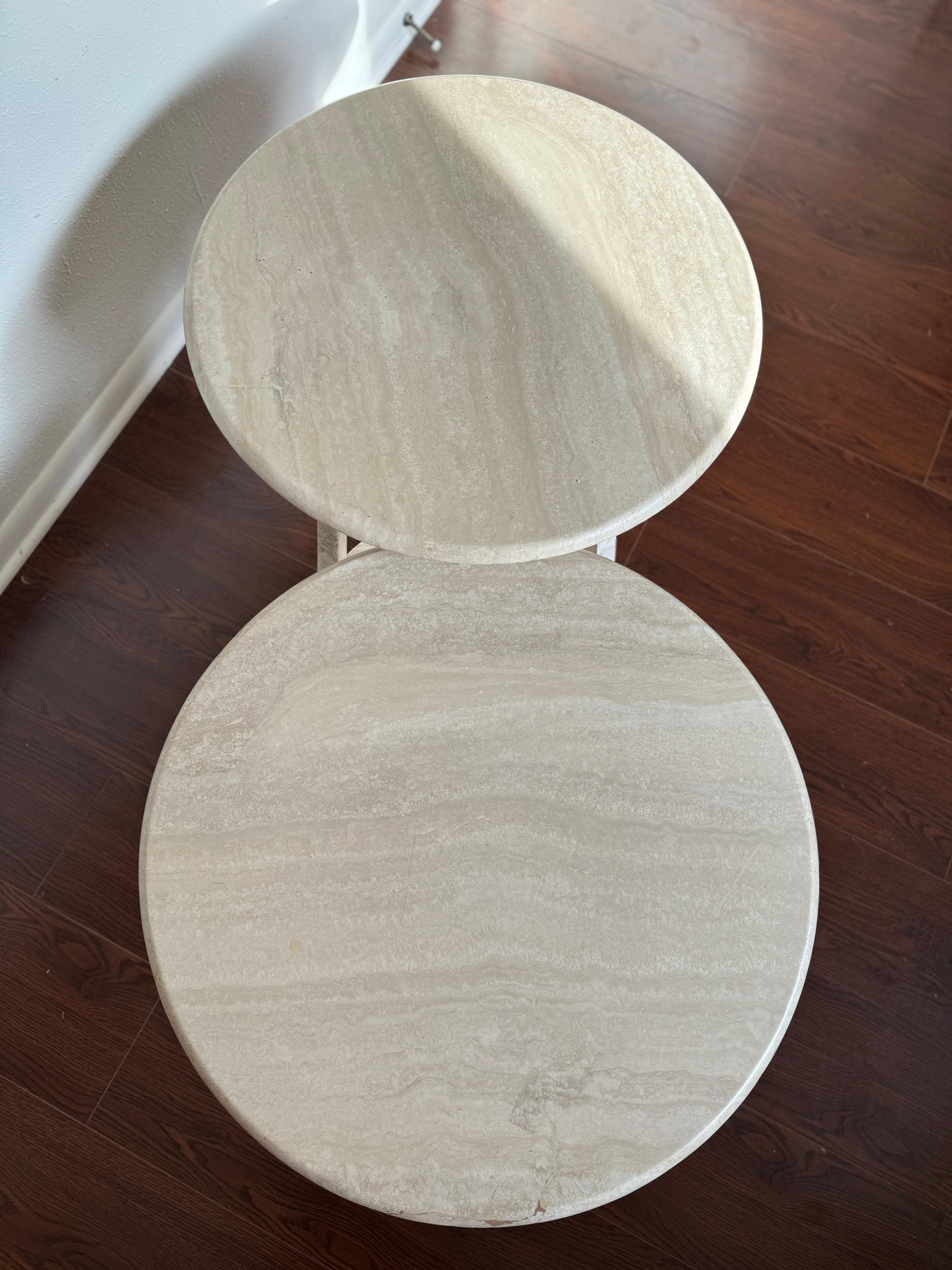 Rare Italian two tier travertine coffee table, circa 1970s. Two round travertine plates sit on an elegant travertine base. Overall in very good condition, and structurally sound. 

17” H x 50” W x 26” D
