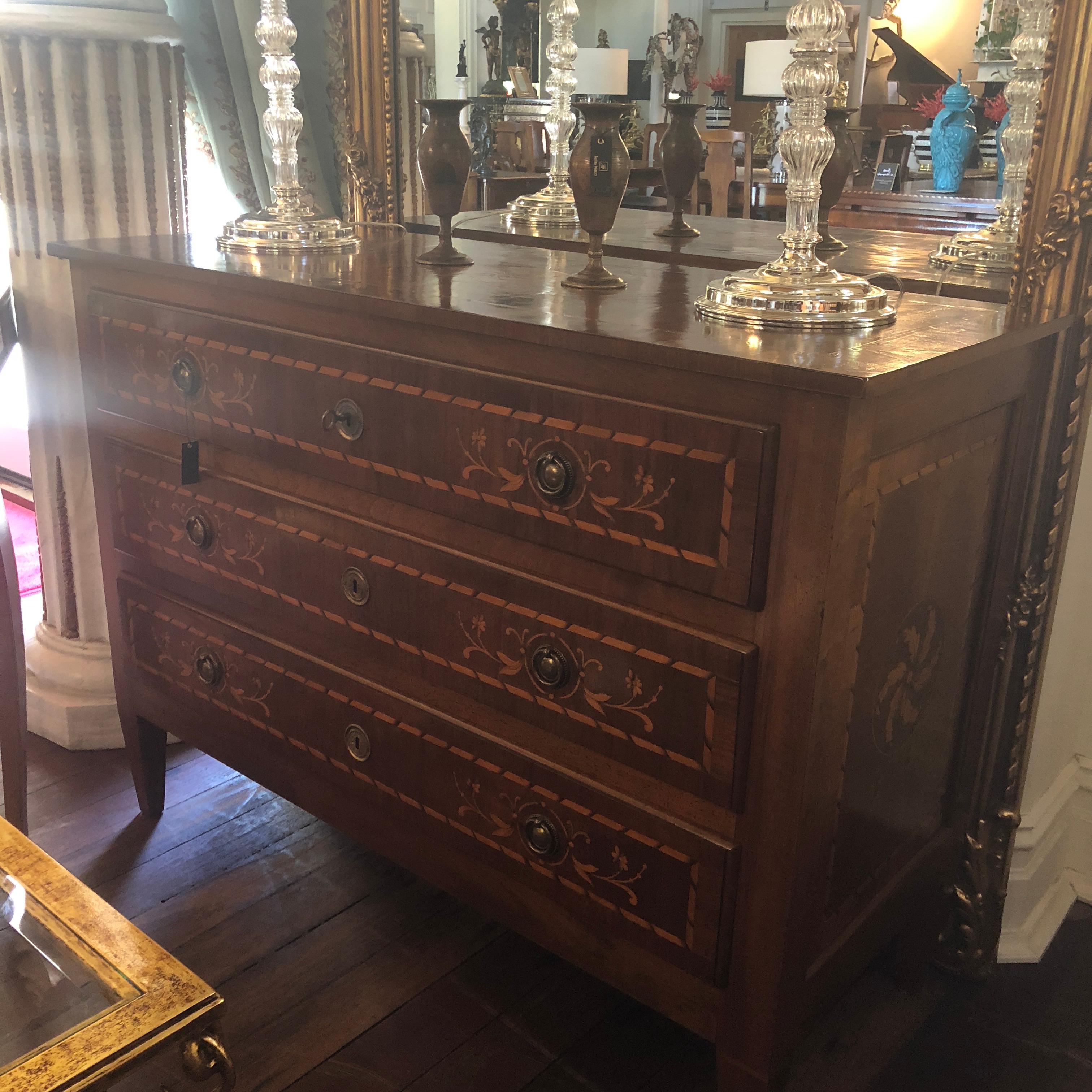 This rare and utterly perfect Italian walnut commode, has been dated in Italy to circa 1700. Featuring the classical Louis XVI form, this commode has been restored to museum quality. On the front, fiore and binding inlay adorns each drawer. In the