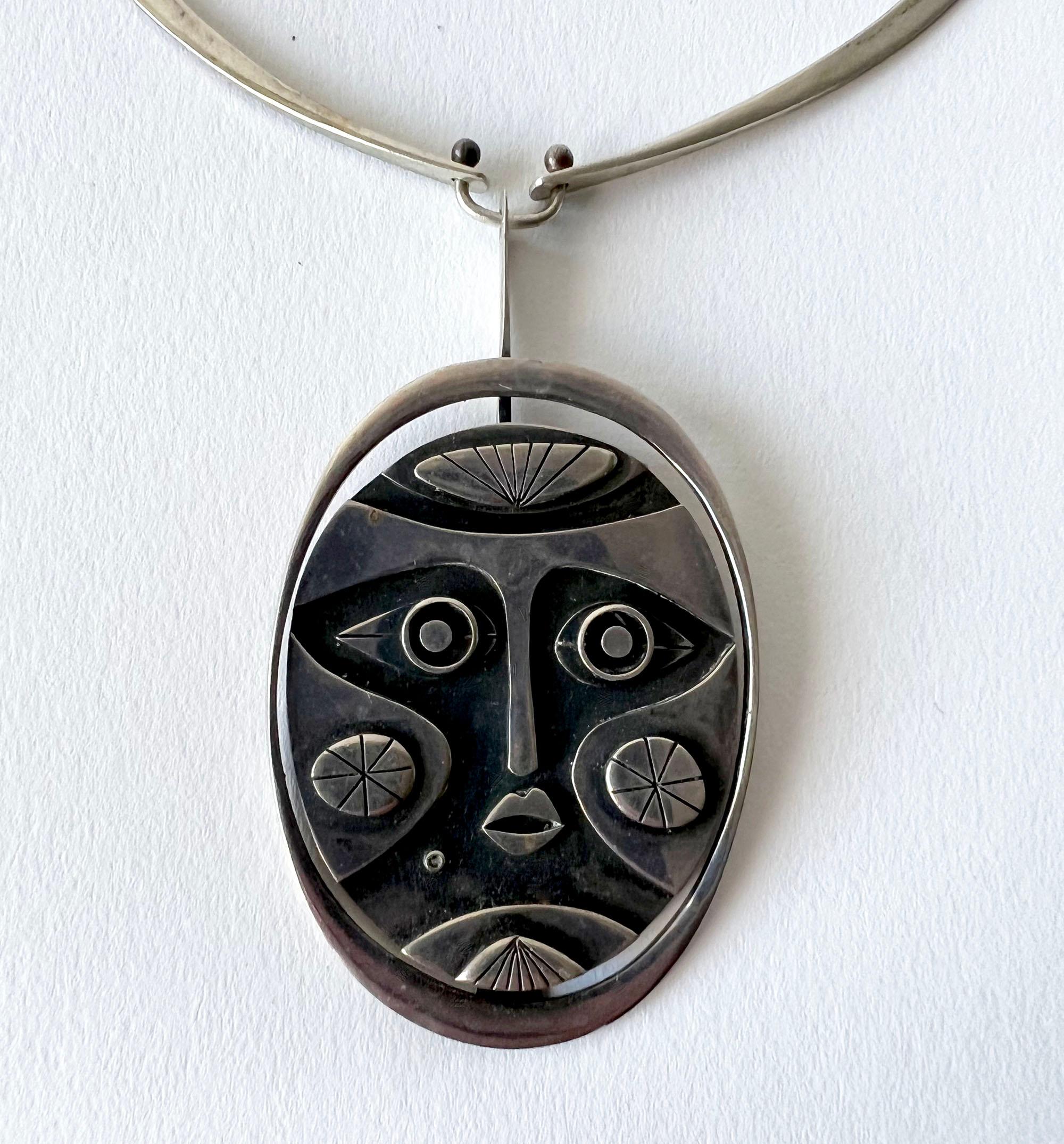 Sterling silver mask pendant necklace created by Jack Boyd of San Diego, California.  Necklace portion measures about 17.5