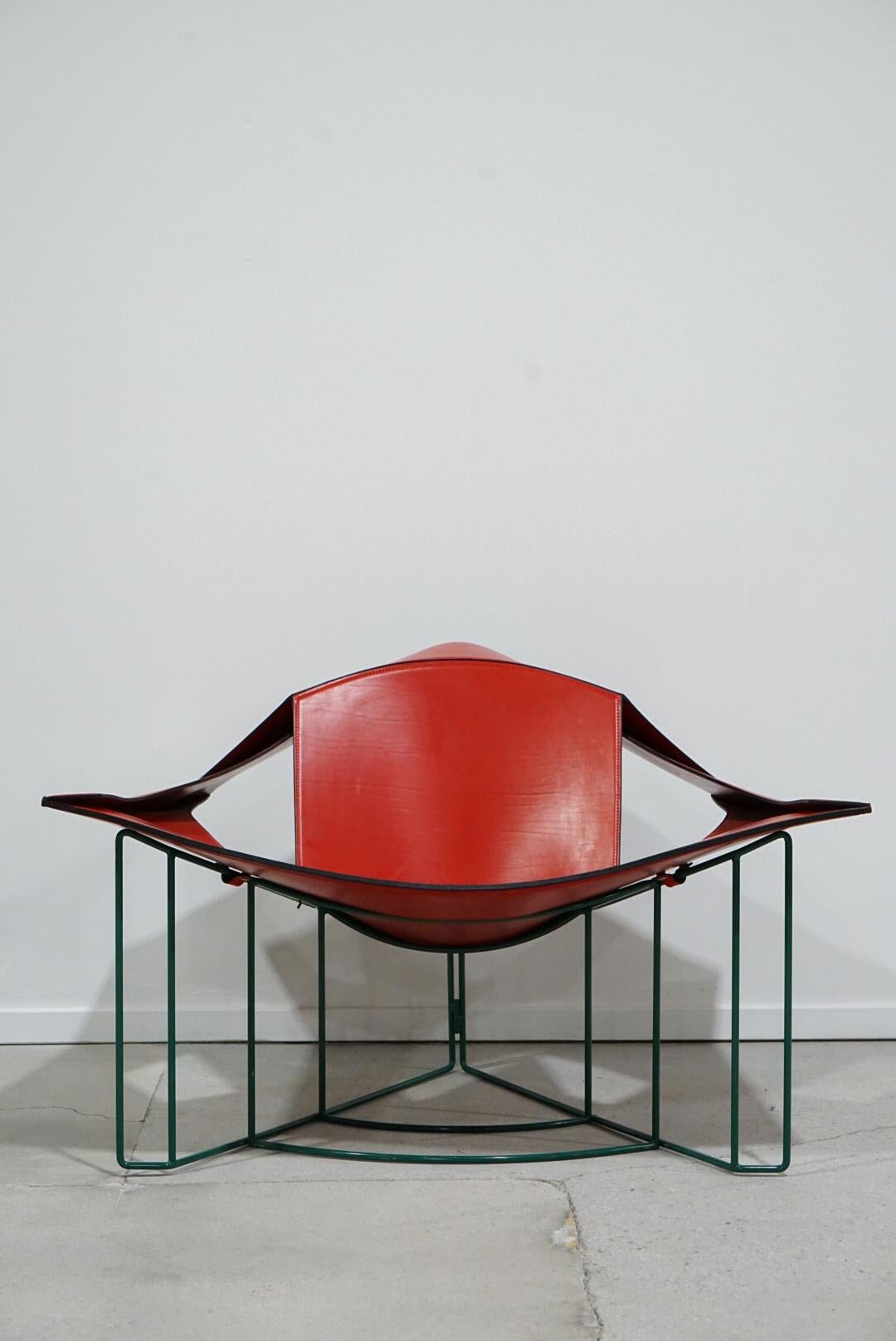 Stunning Lounge chair designed by Jacques Harold Pollard for Matteo Grassi Italy in 1987. Chair is red leather with light patina as pictured and a custom green powder coated frame. This chair is a true work of functional art and a statement piece.