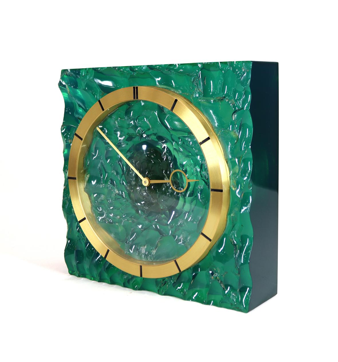 A highly unusual timepiece made by Jaeger LeCoultre in 1968. The case made of solid resin that has been hand knapped to give the impression of the ripples on the surface of the seam the transparent resin catches the light and changes colour