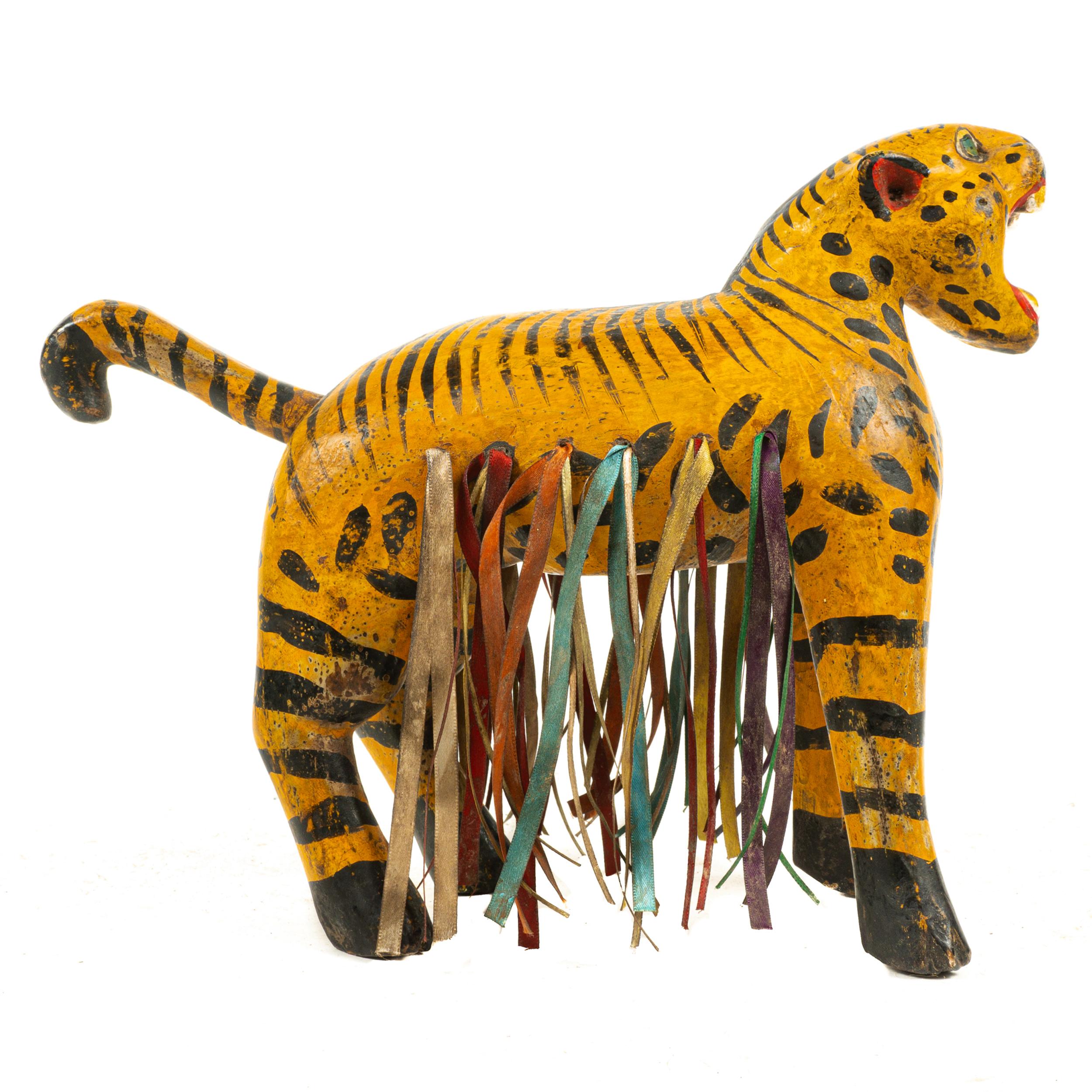This vintage hand carved and hand painted Tiger, is presumed to have been made in or near Chilapa, Guerrero in circa 1940 in a Folk Art style. The carving has been made in a naive style and has been hand painted in detail.

A highly decorative and
