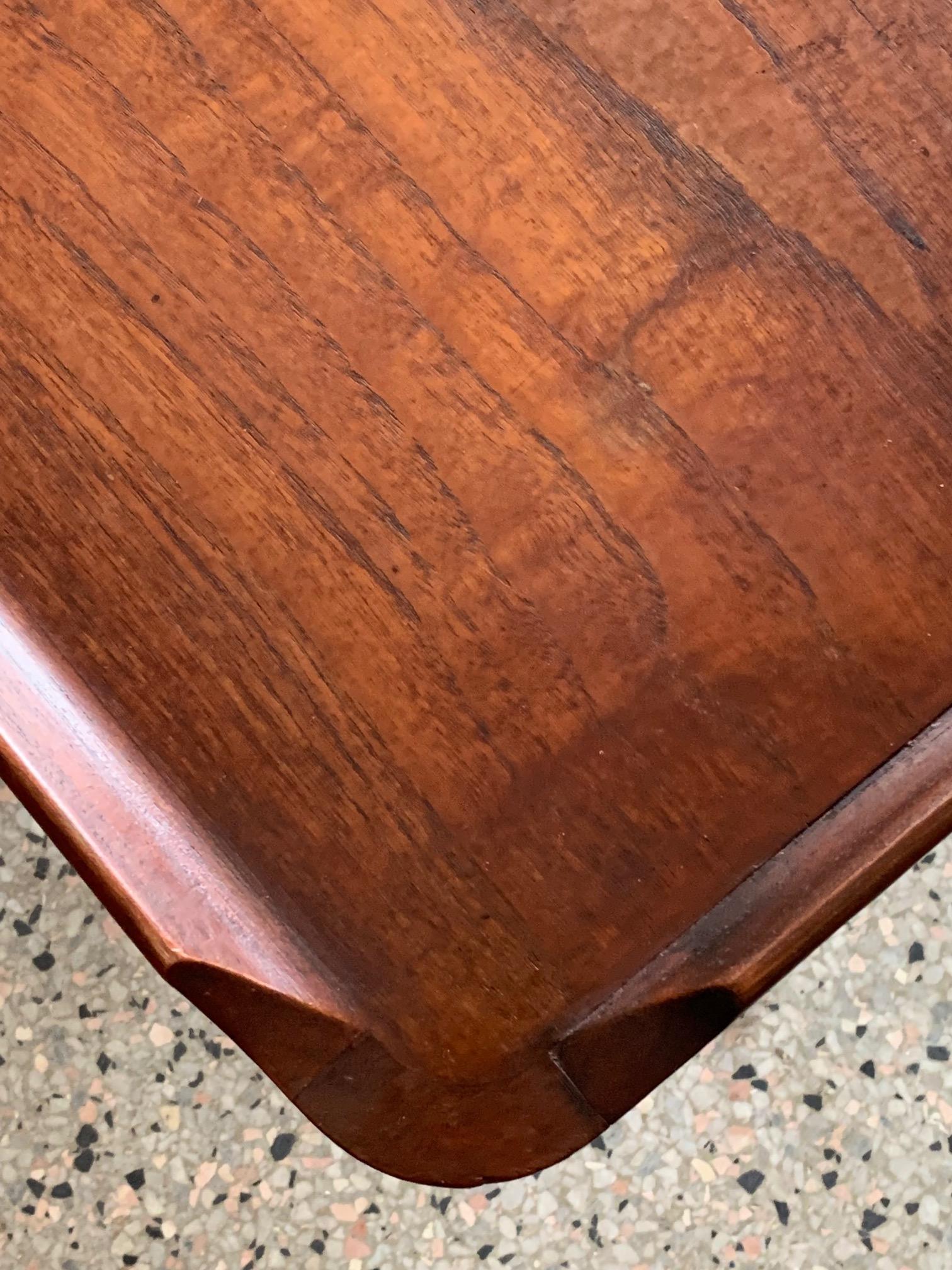 A rare and unusual coffee table with solid raised edges and architectural details, by Jorgen Clausen for Brande Mobelfabrik, Denmark, circa 1950s. Beautiful patina and rich graining.