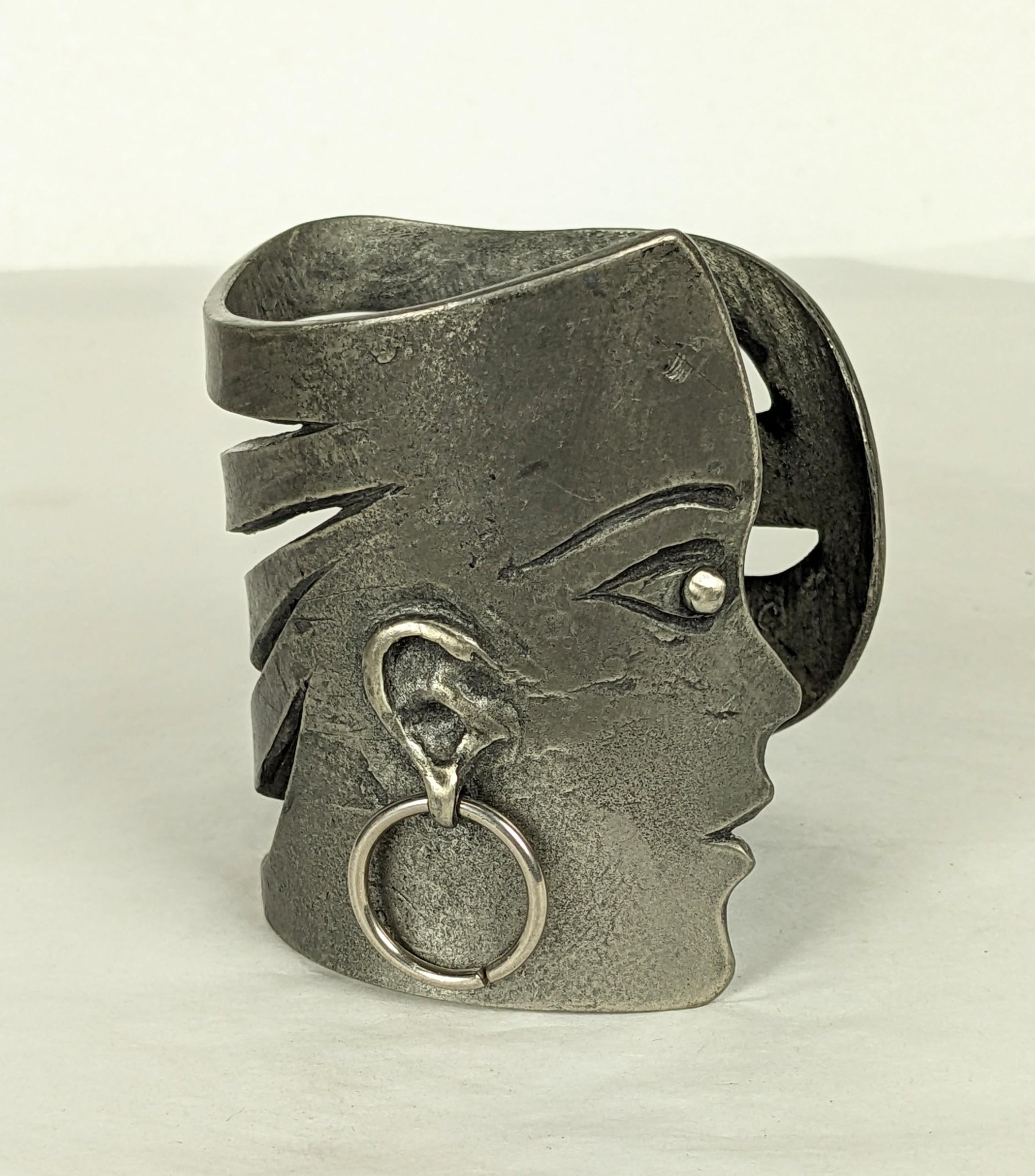 Rare Jean Charles de Castelbajac Figural Runway Cuff from the 1980's. Patinaed silvered metal created by D. Roux for Castelbajac. A female face motif with pierced wavy hair which wraps around wrist. 2.75
