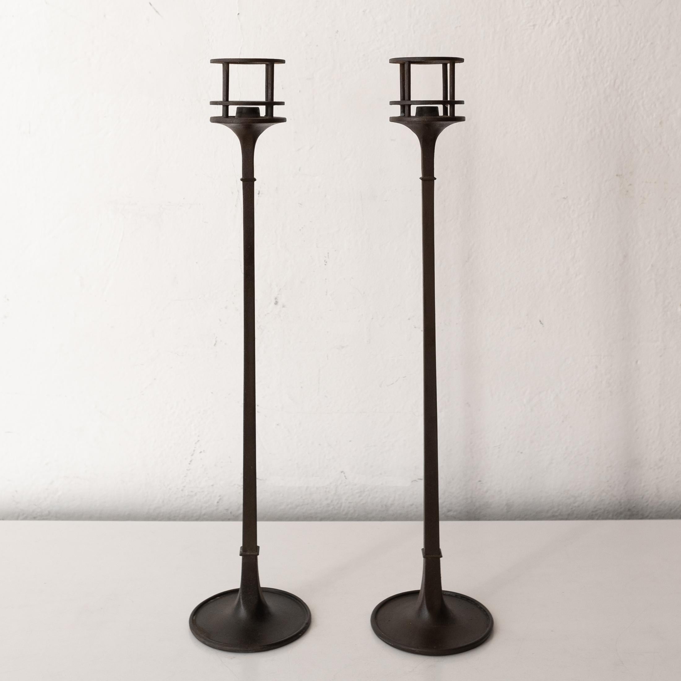 Rare pair of tall candleholders designed by Jens Quistgaard for Dansk. Solid cast iron with brass fittings. Marked on the bottom. Modernist sculptural design from the midcentury. Made in Denmark.