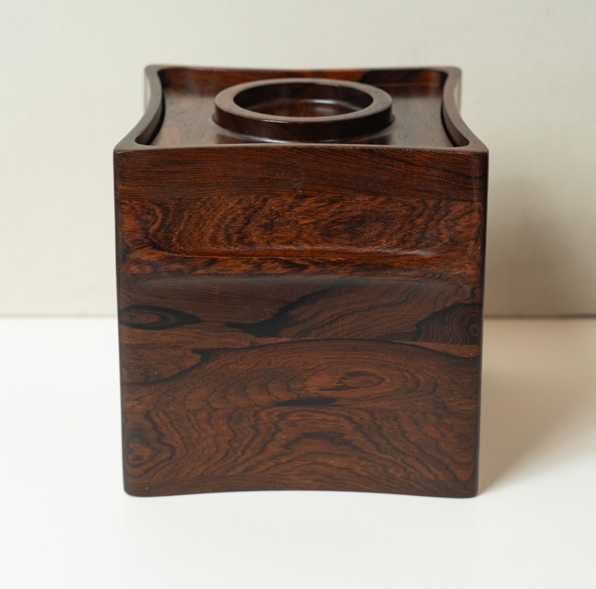 Designed in the 1950s by Jens Quistgaard, this box is one of many designs he came up with for Dansk. This is one of the most special though. One of the largest available, it features solid carved rosewood construction. The grain in this piece is