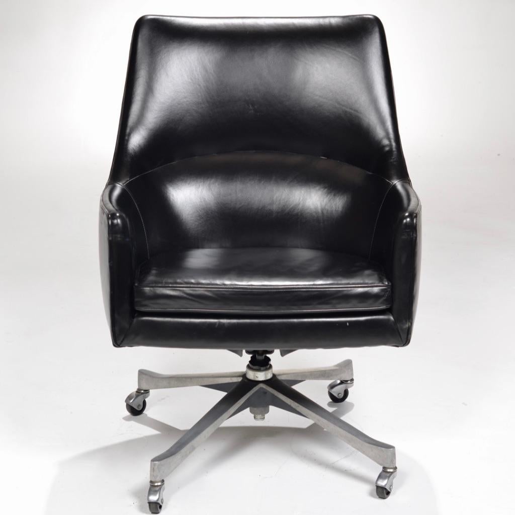 This an extremely rare Jens Risom high back executive armchair for Jens Risom design Inc. It features incredibly smooth black leather upholstery with a beautiful shiny patina and a metal swivel base. This chair is lovely in person and larger than