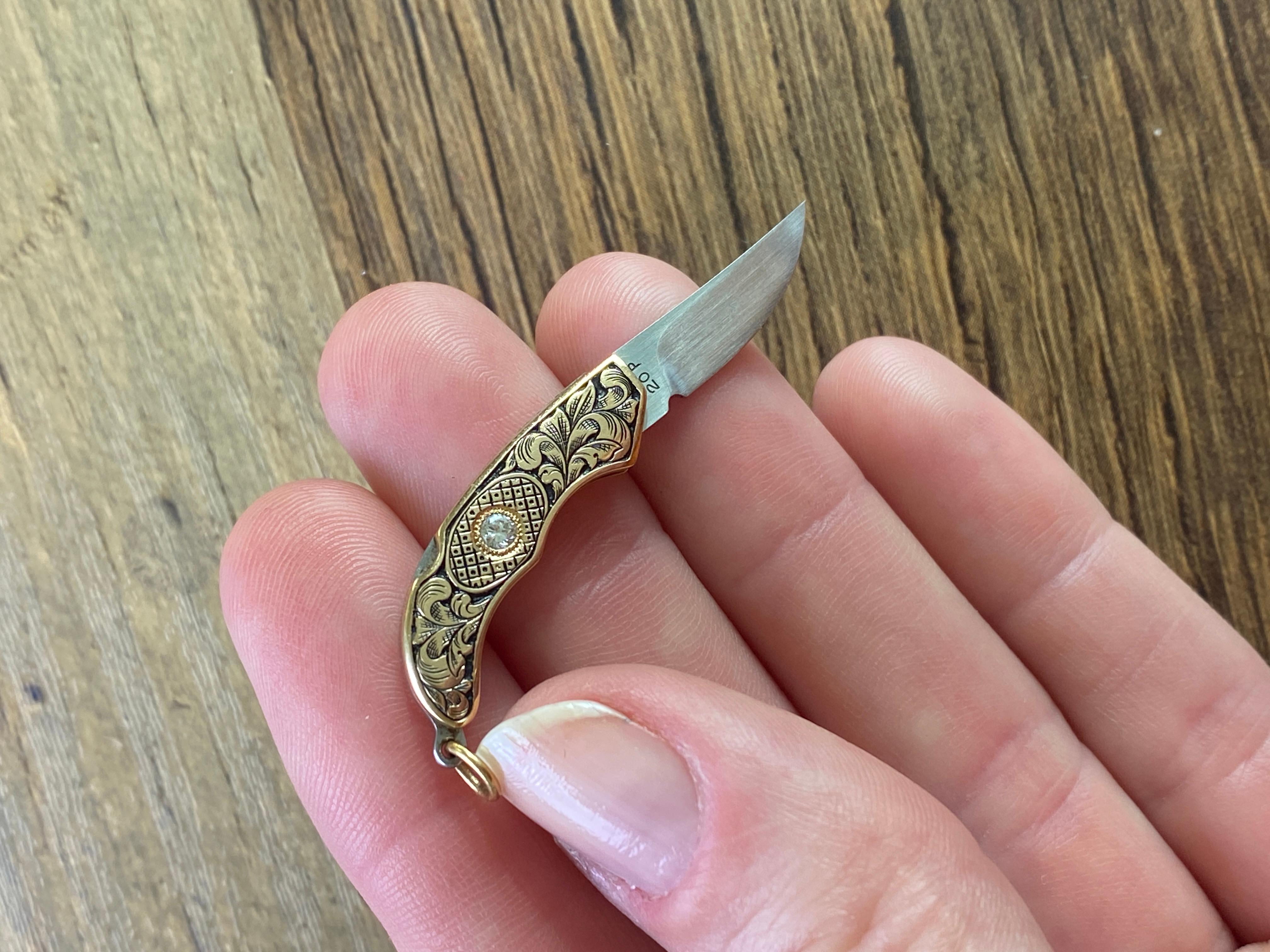 Rare, Jim Martin, Miniature 14kt Yellow Gold Miniature Knife with Diamonds on both sides. Gold ring for necklace. Chain not included. Total weight: 5.5 grams.  Diamond size: 2.25mm, 14k gold, working miniature knife necklace pendant