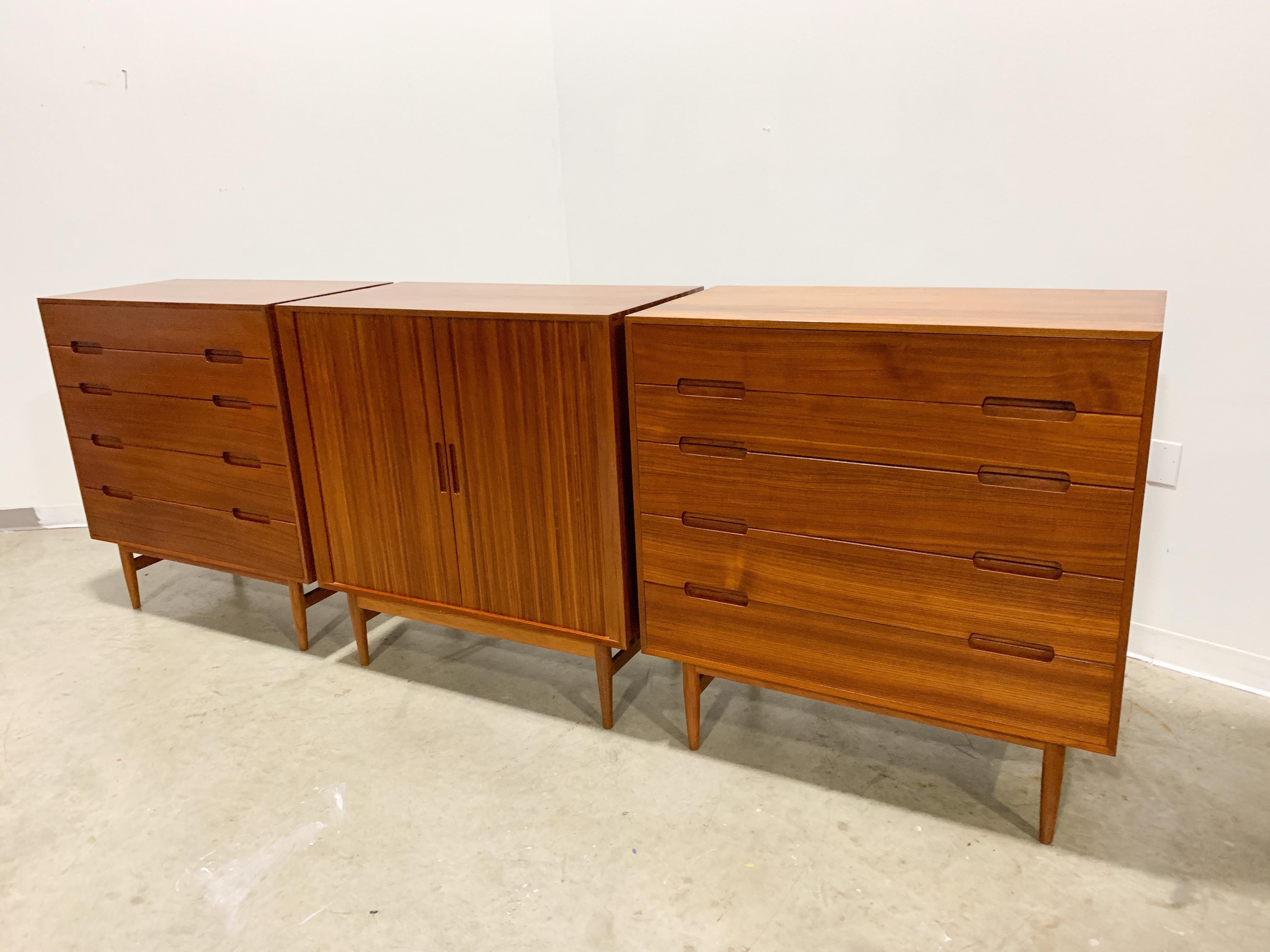 Stunning solid teak (not veneer) construction with dovetailed edges and finger jointed starts. Incredibly rich teak wood grain and subtle drawer pull details. This set is in excellent condition.

Dimensions are for 1 of the 3 included pieces of
