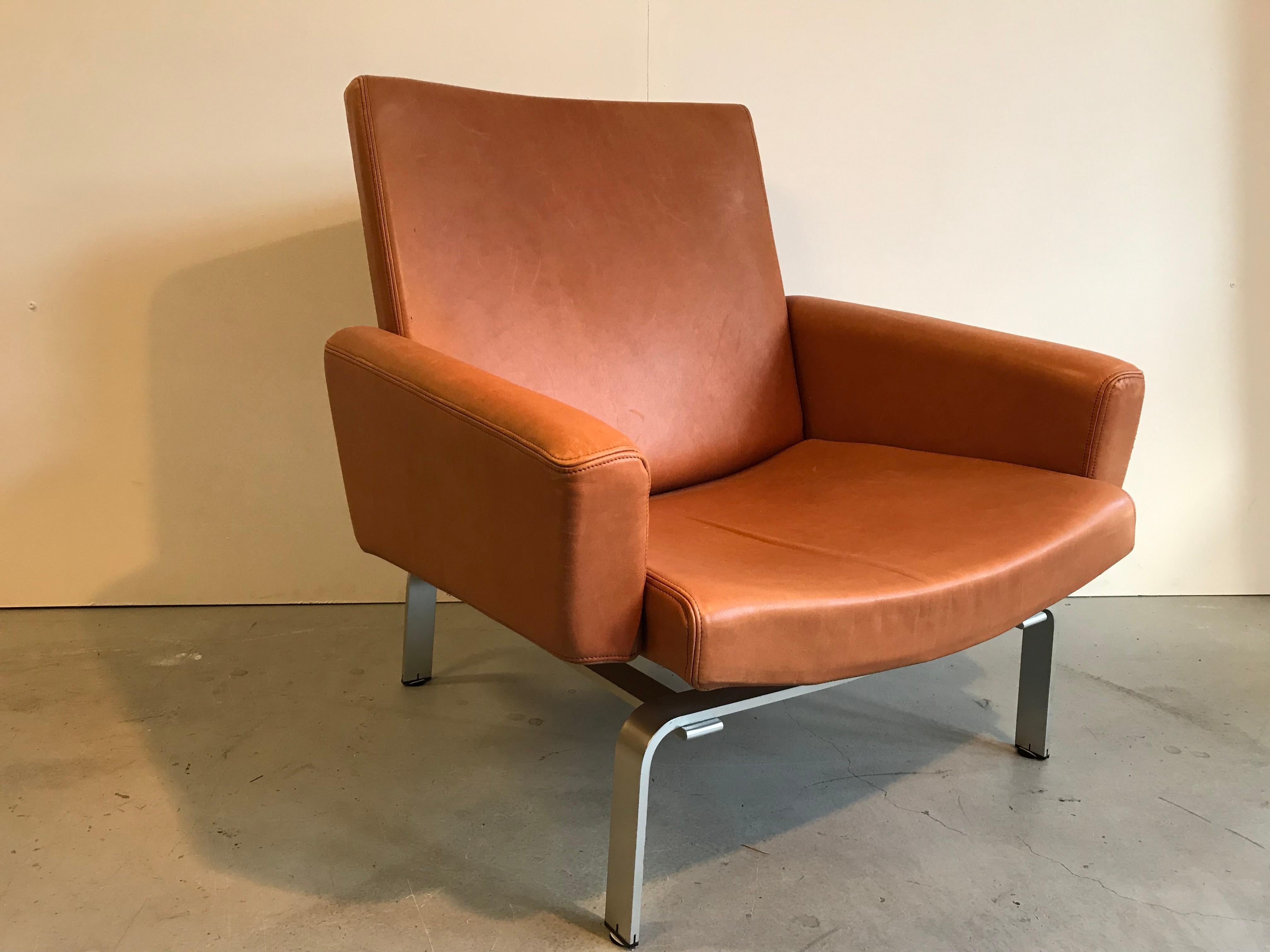 Jorgen Hoj Sessel. 
Entworfen für Niels Vitsoe in den 1960er Jahren. 

Dieser schöne und nicht leicht zu findende Stuhl ist mit Naturleder gepolstert und hat massive Aluminiumfüße. 

Das Leder hat eine tolle Patina, auf einer Armlehne jedoch,
