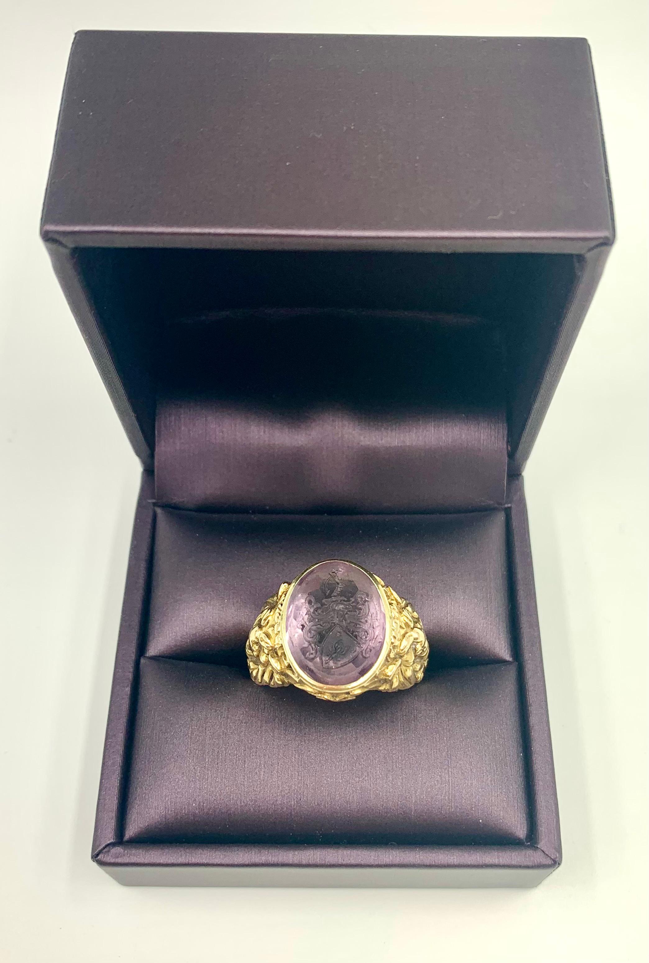 An exceptional museum quality signed Josef Seiss oval amethyst intaglio 14K yellow gold signet ring
A pair of sinuously sculptural gold lions flank a superb amethyst intaglio depicting an ornate shield shaped heraldic crest with a star, moon and