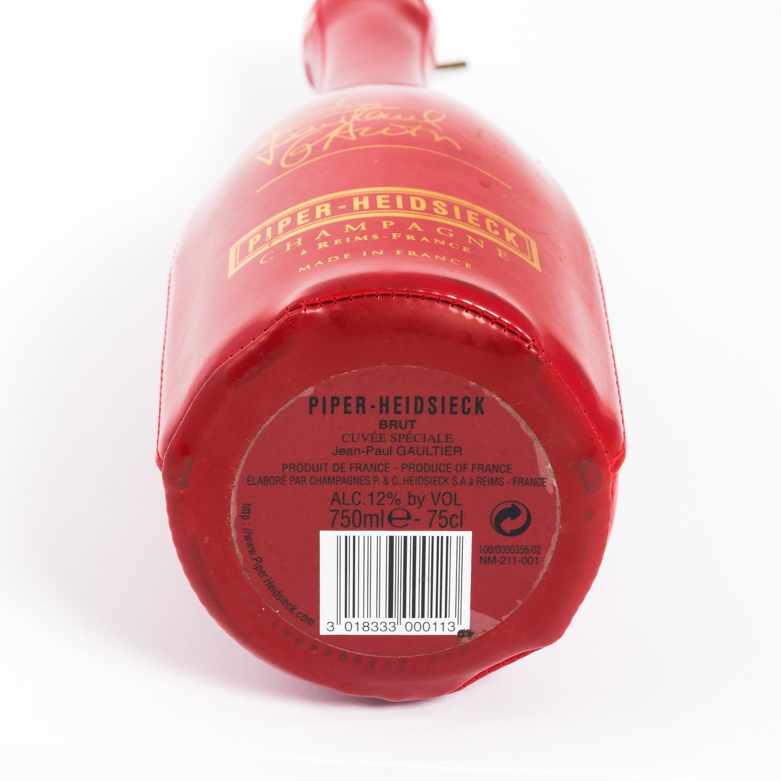 Jean Paul Gaultier red and gold vinyl corset champagne bottle and holder. Limited edition created for the champagne brand Piper-Heidsieck. Made in France, circa 1990s.
 