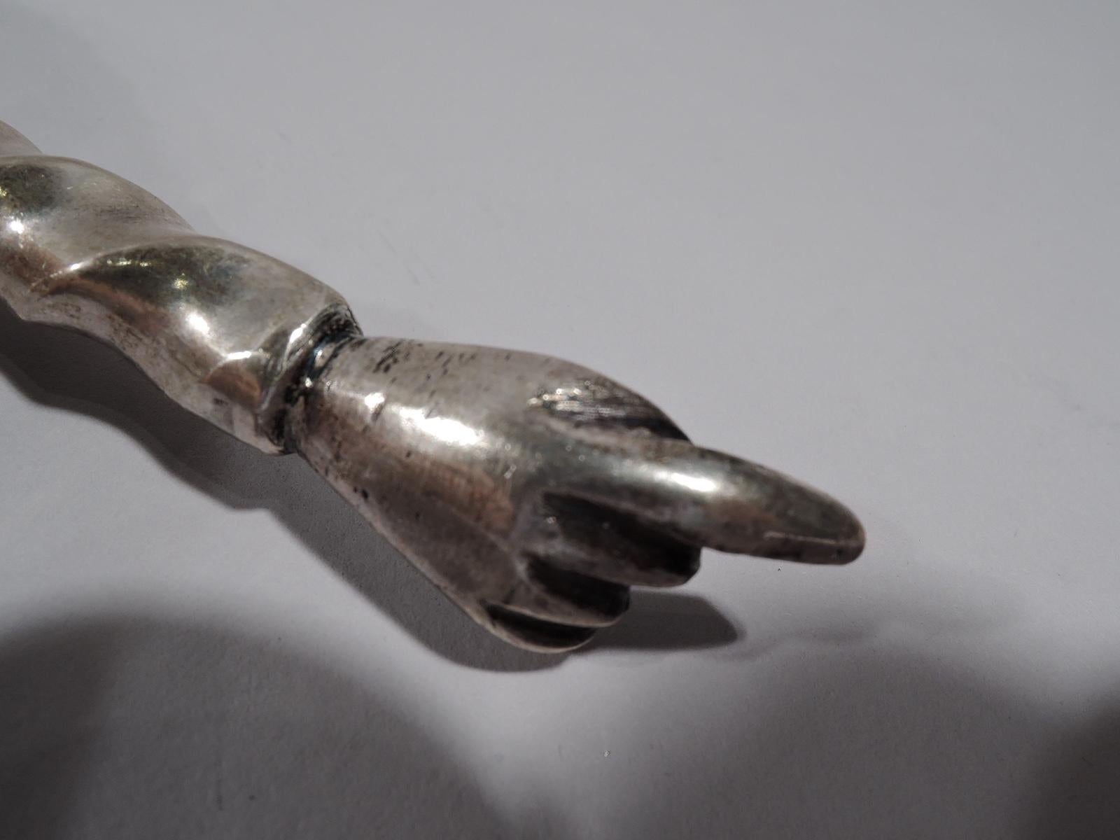 Austrian silver Torah pointer, 1829. A cast hand with extended index finger mounted to a twisted and faceted shaft with ball knop and terminal. Loose-mounted ring with chain. Marks include year. 

Measures: Length (without ring and chain) 10 1/4