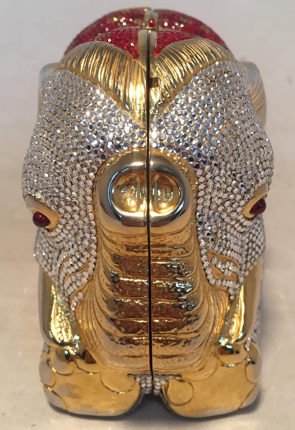 RARE Judith Leiber Swarovski Crystal Elephant Minaudiere Evening Bag Clutch in excellent condition. Adorable gold metal body in the shape of a sitting elephant covered completely with clear crystals, red gem eyes, and red, clear, black, and gold