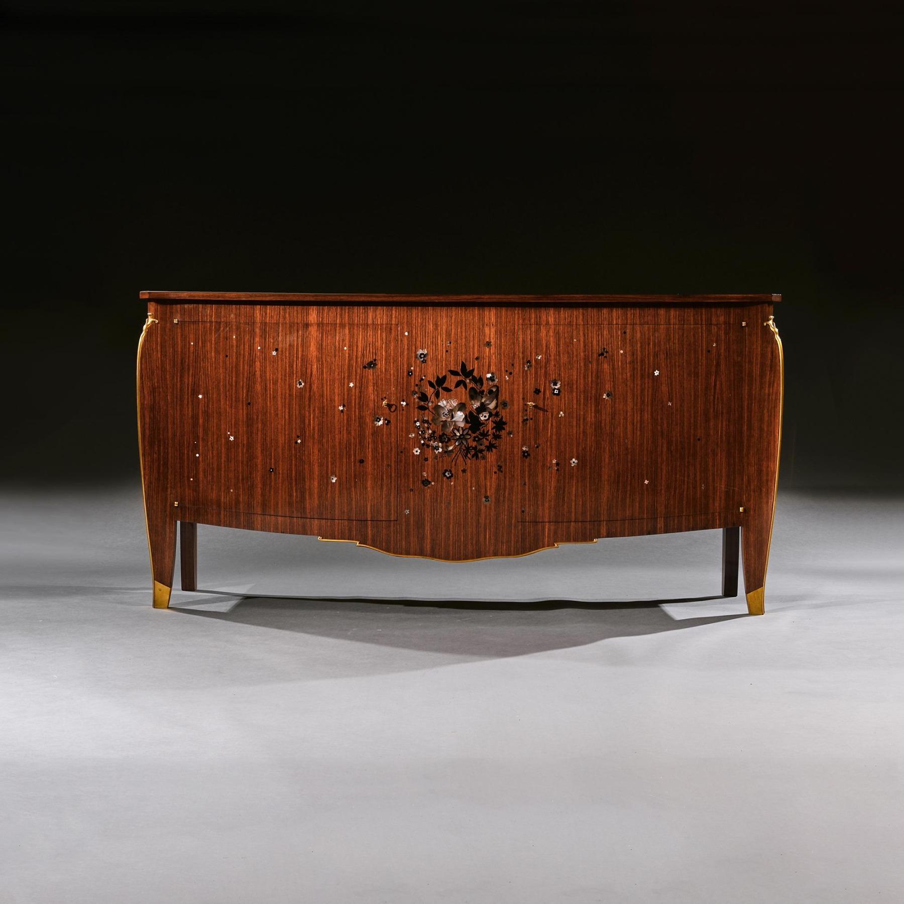 A rare Art Deco commode / sideboard by Jules Leleu in palisander wood with ebony and mother of pearl inlaid marquetry and bronze mounts, by Jules Leleu (1883-1961) model number 2873.

French - Paris, circa 1939.

A masterpiece of design and