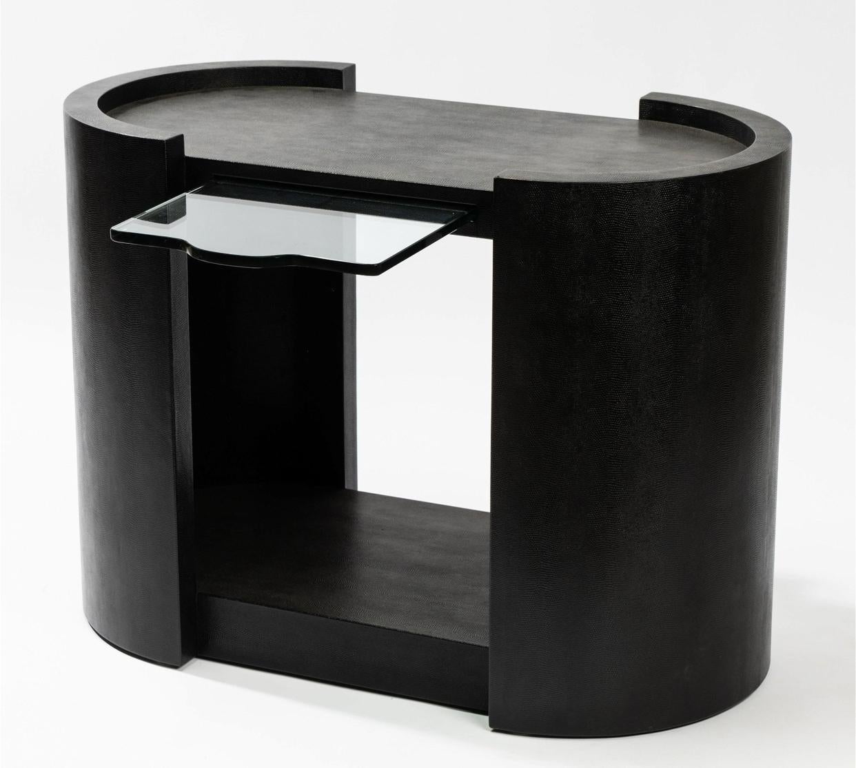 Rare Karl Springer race track oval two tiered side table, wrapped in black lizard skin embossed leather. This hard to find table also features a pull out glass shelf for anything from writing to drink placement. The curved sides are a classic design