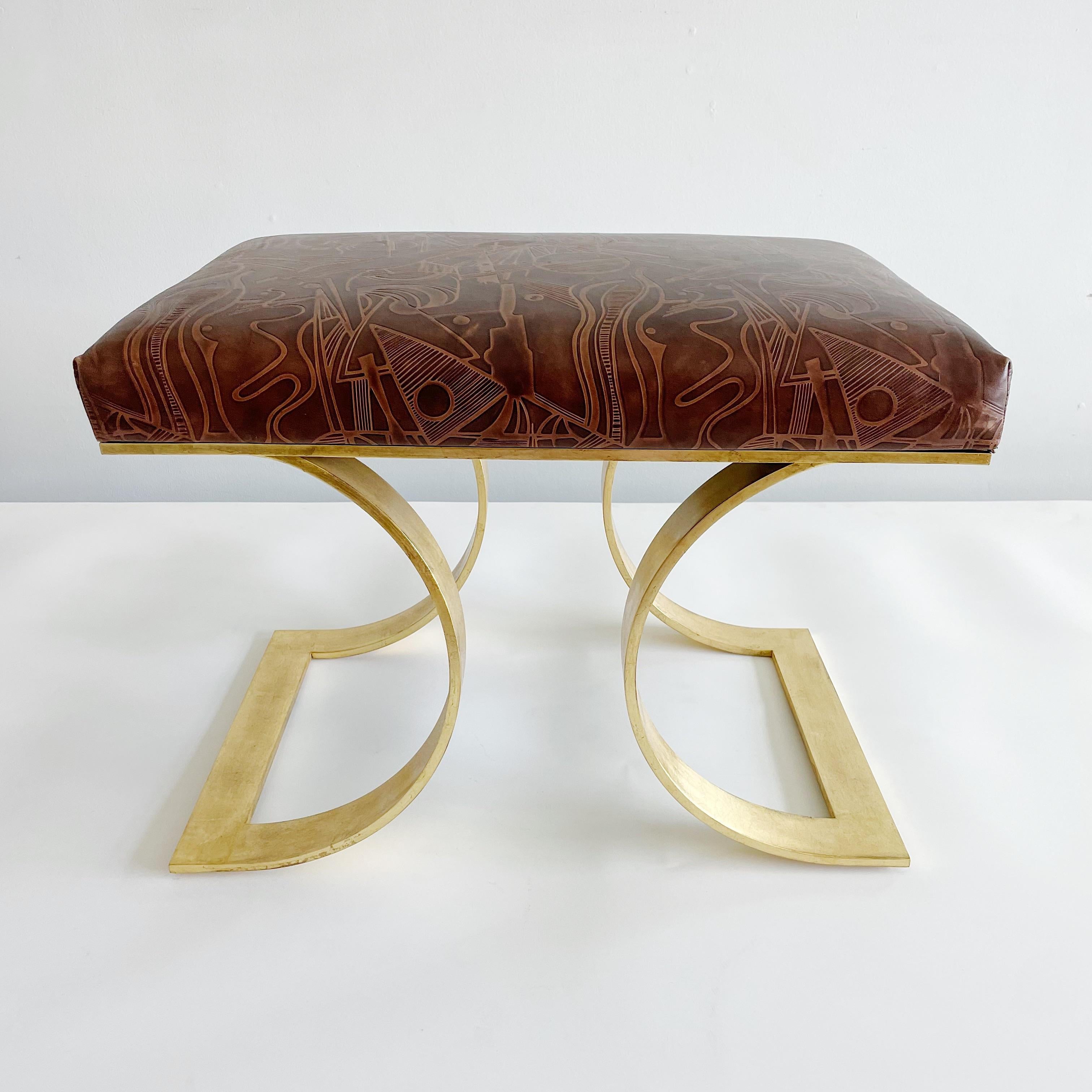 This is the original prototype for Karl Springers JMF bench. Executed in fabulous tooled leather with abstract design, gold leaf brass legs and gold leaf steel frame. Signed on underside and verified by Karl Springer LTD