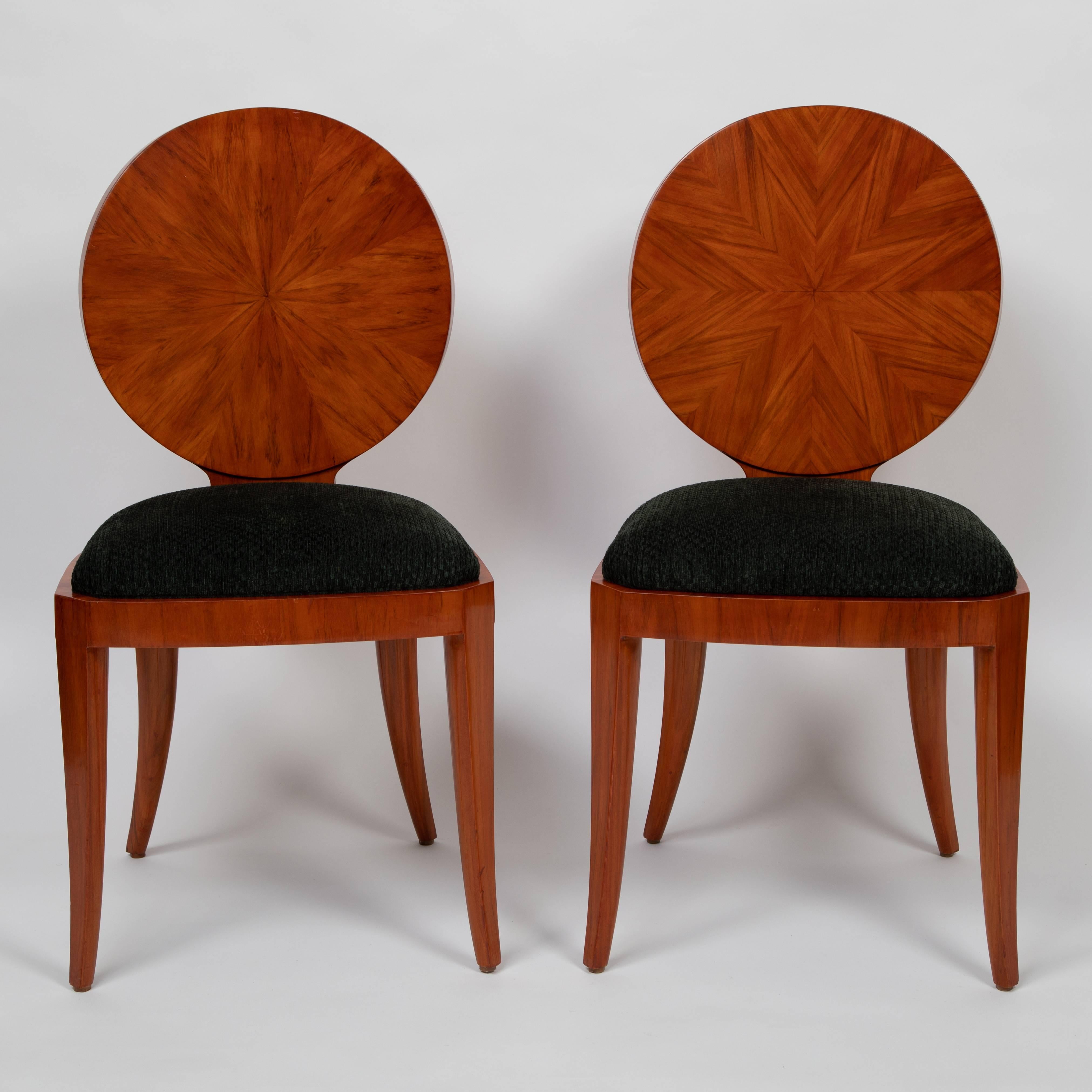 A very rare pair of occasional chairs by Karl Springer in a neoclassical style with a modern twist. The curved, circular backs feature mahogany veneer meticulously applied in two different sunburst patterns. The front and rear legs are flared and