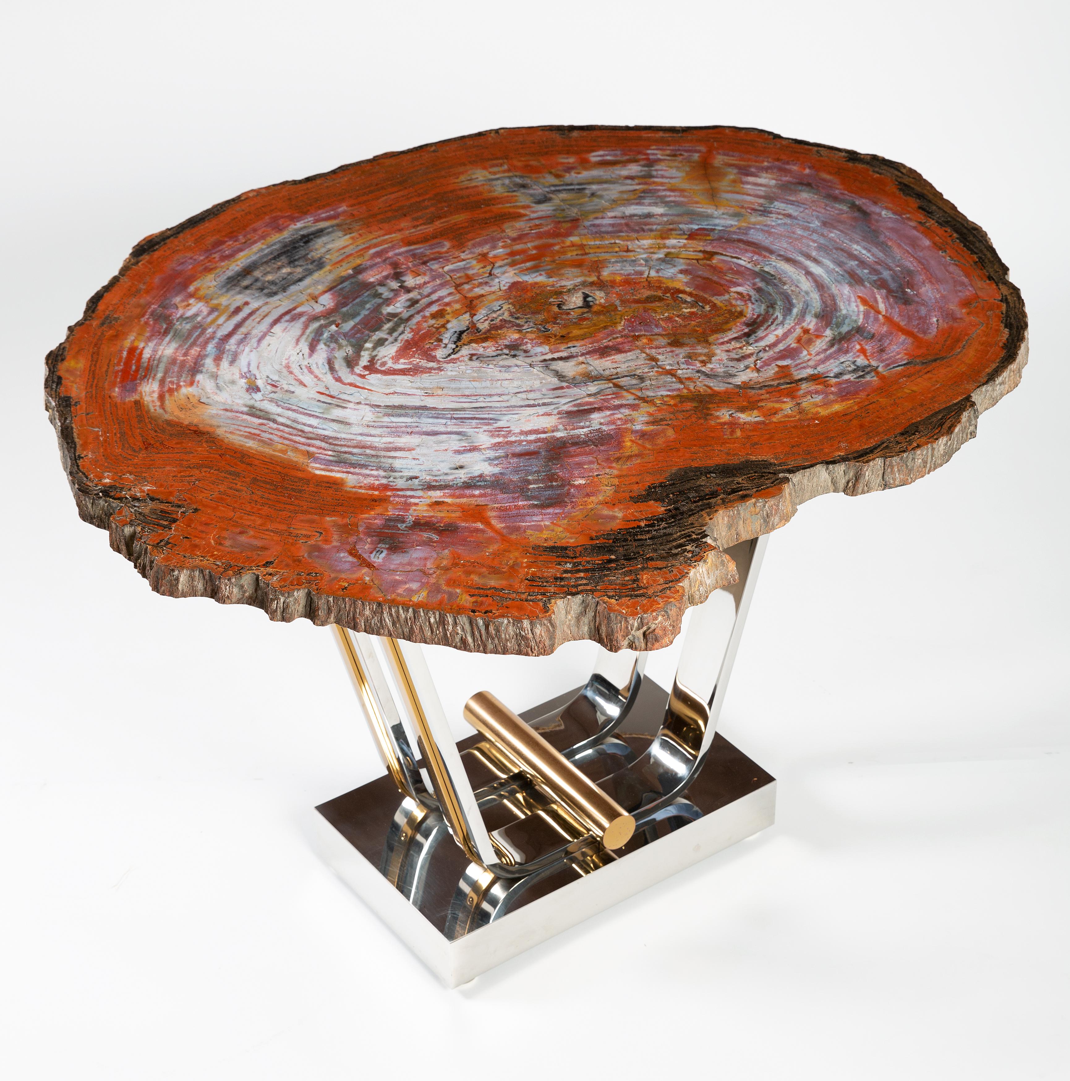 Important Karl Springer Table with Petrified Wood. Featuring a tulip base of polished stainless steel and polished brass. Size and height of table is ideal for serving, dining and games. This is an authentic Karl Springer design from the period. The