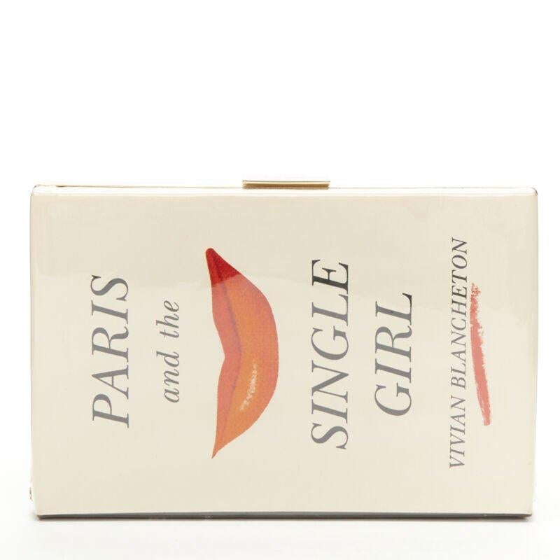 rare KATE SPADE Paris And The Single Girl Vivian Blancheton book clutch bag
Reference: KEDG/A00165
Brand: Kate Spade
Material: Fabric, PVC
Color: Beige, Red
Pattern: Lips
Closure: Clasp
Lining:  Fabric
Extra Details: Book inspired illustration