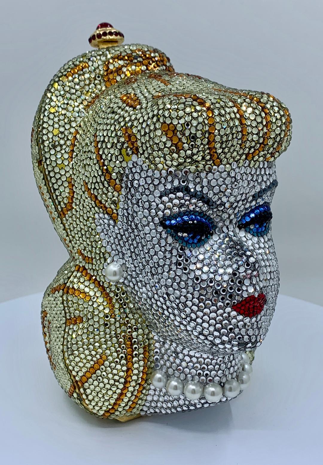 A rare, limited-edition, artist proof, signed and numbered, Swarovski crystal encrusted, gold-plated metal Barbie head shaped minaudière evening bag purse by celebrated handbag maker to the stars, Kathrine Baumann. This evening bag is numbered on a