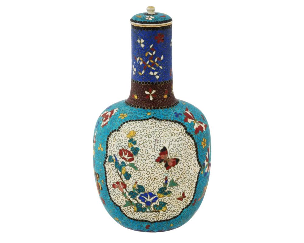 An antique Japanese Meiji era, 1868 to 1912, Totai Shippo cloisonne enamel and porcelain sake bottle. Decorated with finely detailed birds, flowers and butterflies in turquoise blue field, two cream medallions on the recto and verso side, banded