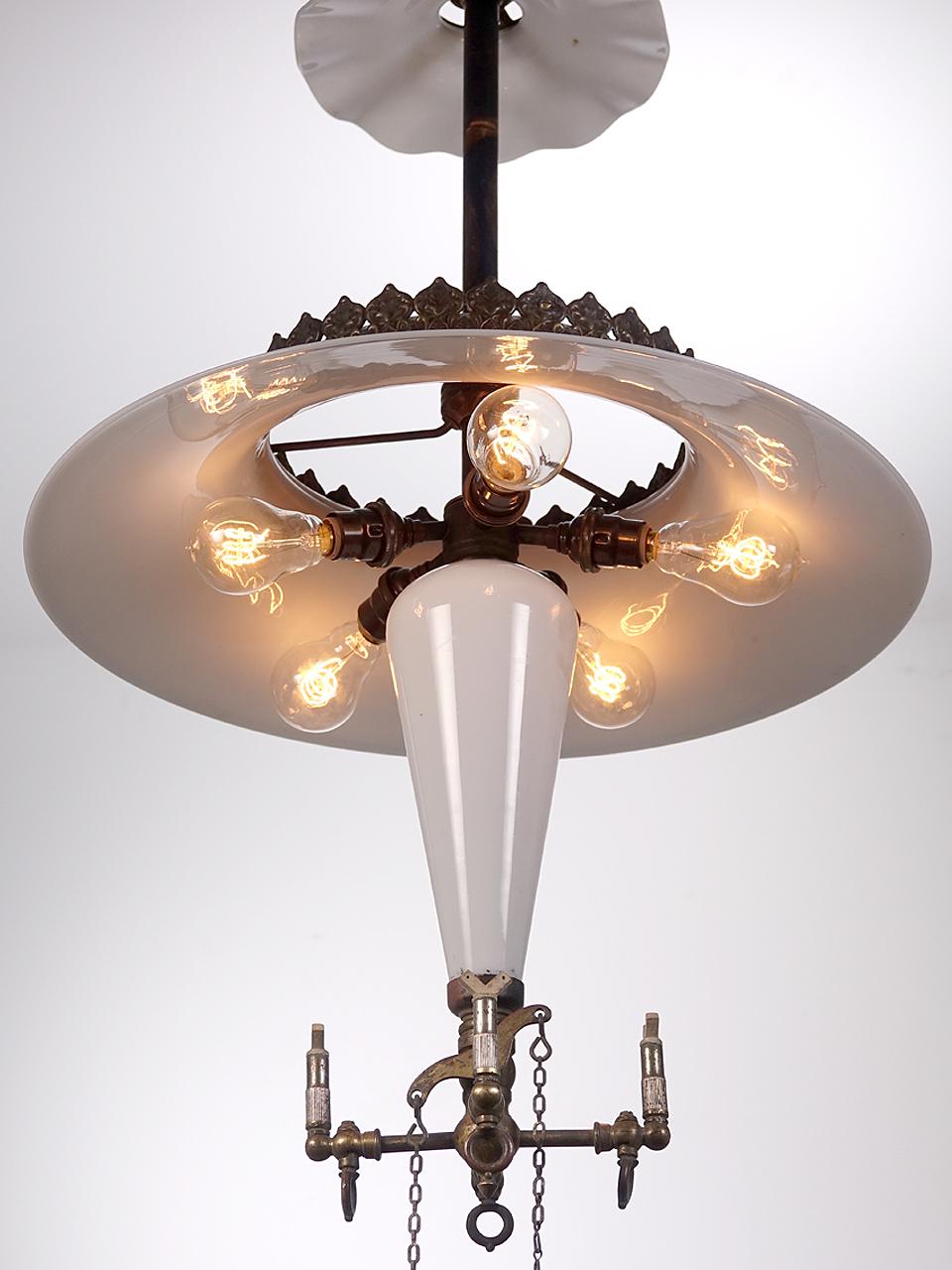 This is a lamp that you would have found hanging in an early Pharmacy. They have great detail including a large 17 inch tented milk glass shade and brass crown. The central milk glass cone reflector is its most unique feature that is found only on