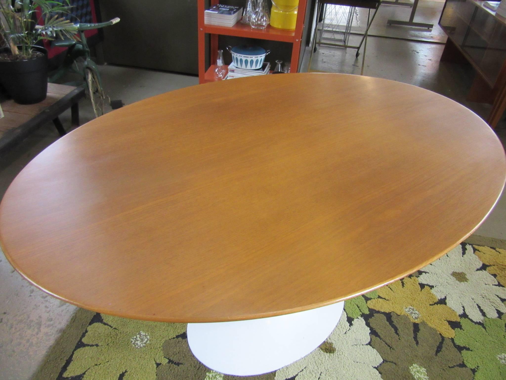 An early special order smaller scale oval walnut topped dining table with matching oval shaped cast iron tulip base. This table looks exactly like the larger version but it's half the size for that tight eat in kitchen, dining area or entrance way,