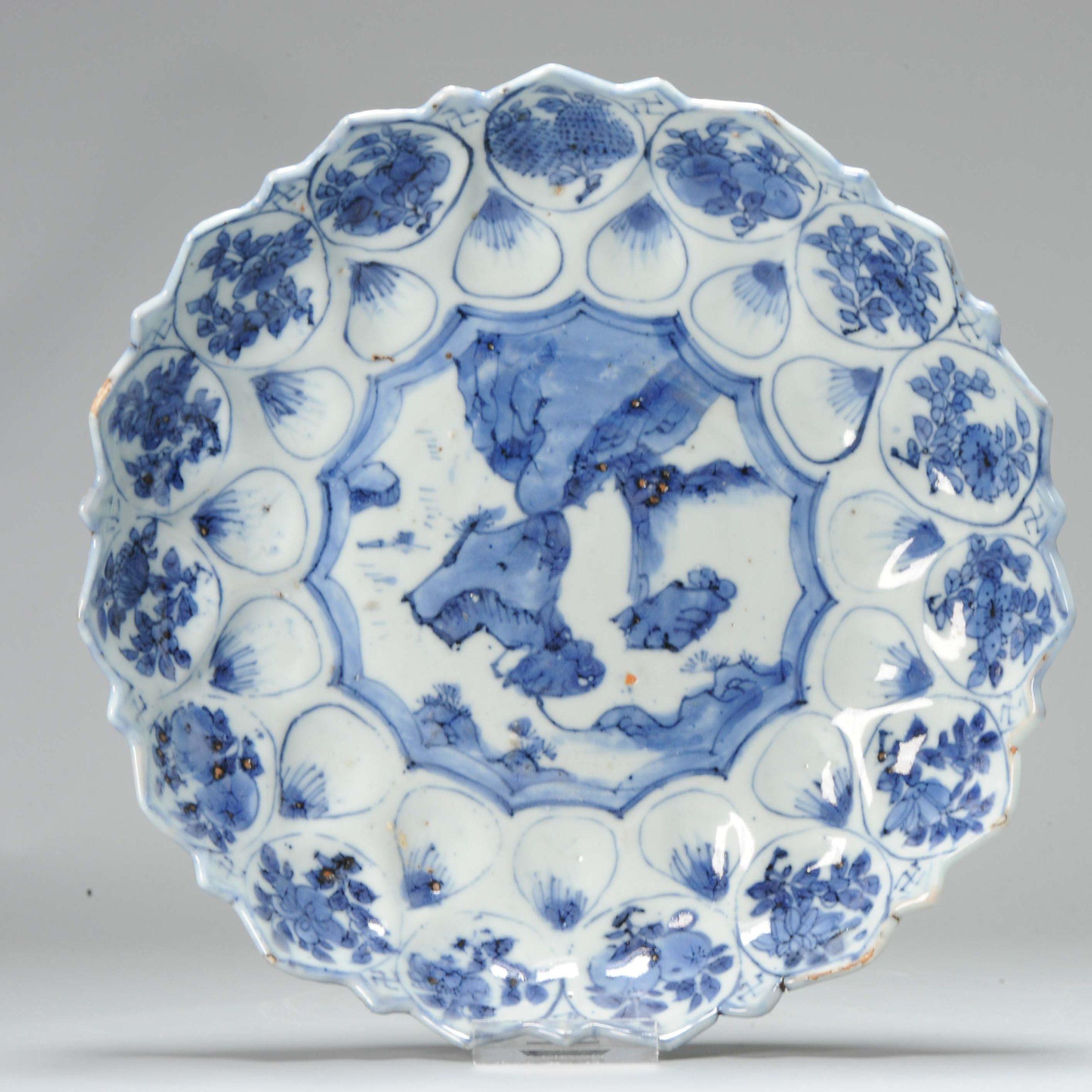 Beautiful dish in blue and white. This is a Jingdezhen made dish made for the Japanese market. Kosometsuke.

The rim of the dish is in the shape of a flower, the dis is overall shaped in the form of a flower also. Central scene of a rocky