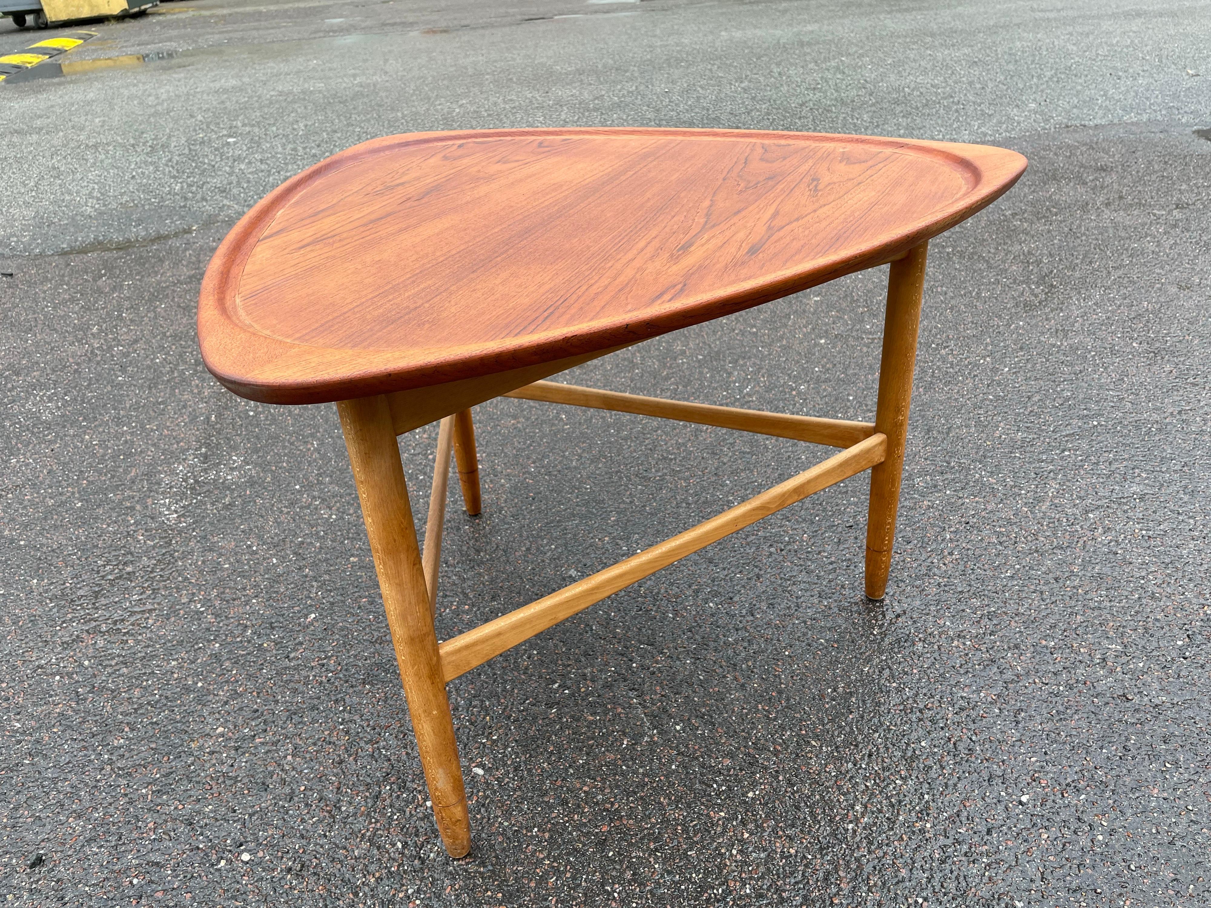 Stunning vintage modern coffee table / side table by Kurt Ostervig features unique sculpted oak legs.