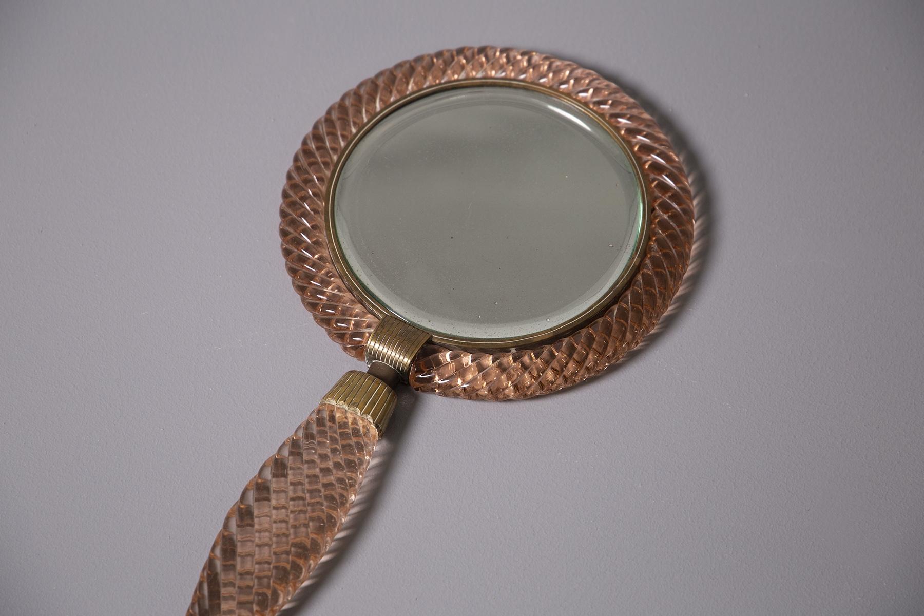 Rare and magnificent ladies' toilet mirror designed by Venini from 1939, Italy. The women's mirror is made in press or rather braided in antique pink Murano glass. Inside there is an antique circular mirror. Its connecting elements are in worked