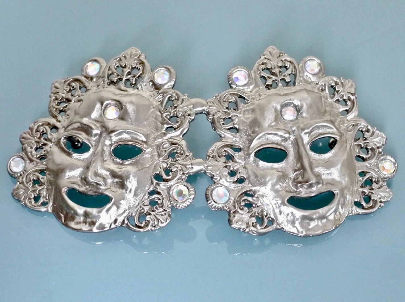 RARE LALOON Mask Belt

Measurements:
Length: 7 inches ( longest part )
Height: 3. 6/8 inches ( widest part )

Features:
- Massive detailed sculptured buckle in silver.
- Each mask is surrounded with baroque details and adorned with clear
