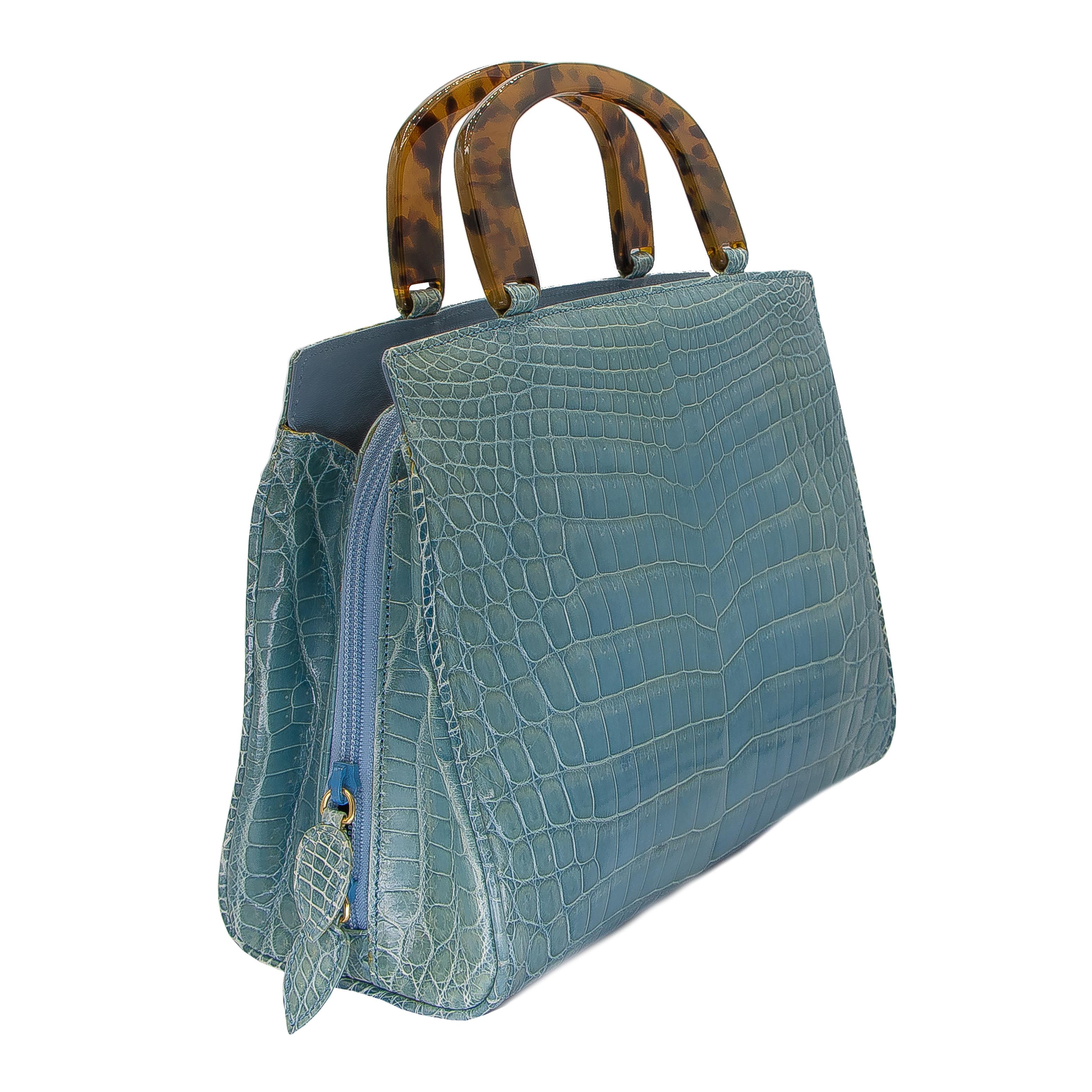 Double zippered middle section with crocodile appointments. Within this, there are 3 side pocket and a 4th zippered pocket. This bag also has a pocket either side of the zippered middle section, and an exterior pocket with a magnetic closure. The