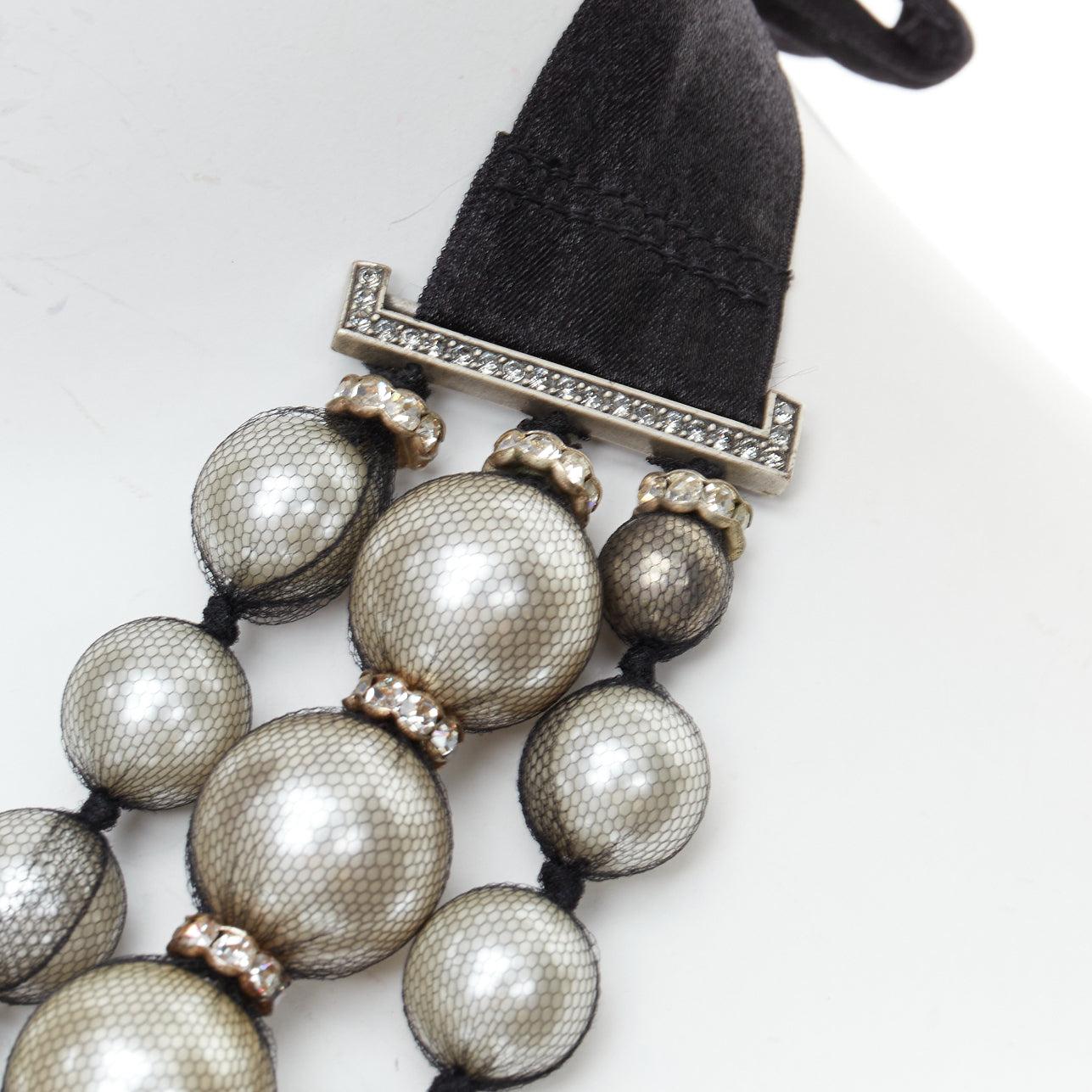 rare LANVIN black strand wrapped faux pearl crystal ribbon tie necklace
Reference: TGAS/E00871
Brand: Lanvin
Designer: Alber Elbaz
Material: Fabric, Faux Pearl
Color: Black, Pearl
Pattern: Solid
Closure: Self Tie

CONDITION:
Condition: Excellent,
