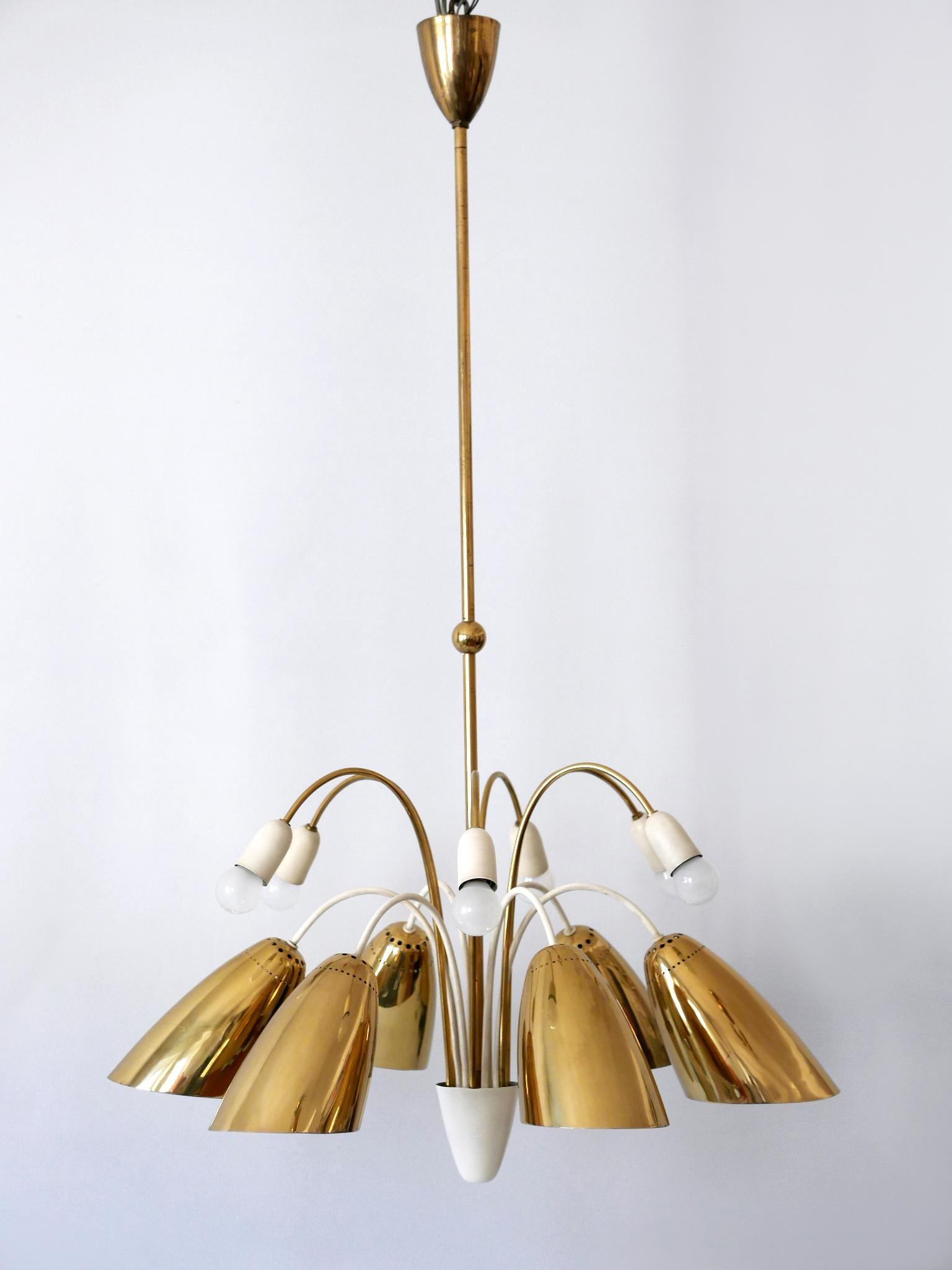 Extremely rare, large & highly decorative Mid-Century Modern 12-armed sputnik chandelier or pendant lamp. Designed and manufactured by Vereinigte Werkstätten, Germany, 1950s.

Executed in brass and metal, the chandelier needs 6 x E27 / E26 and 6 x