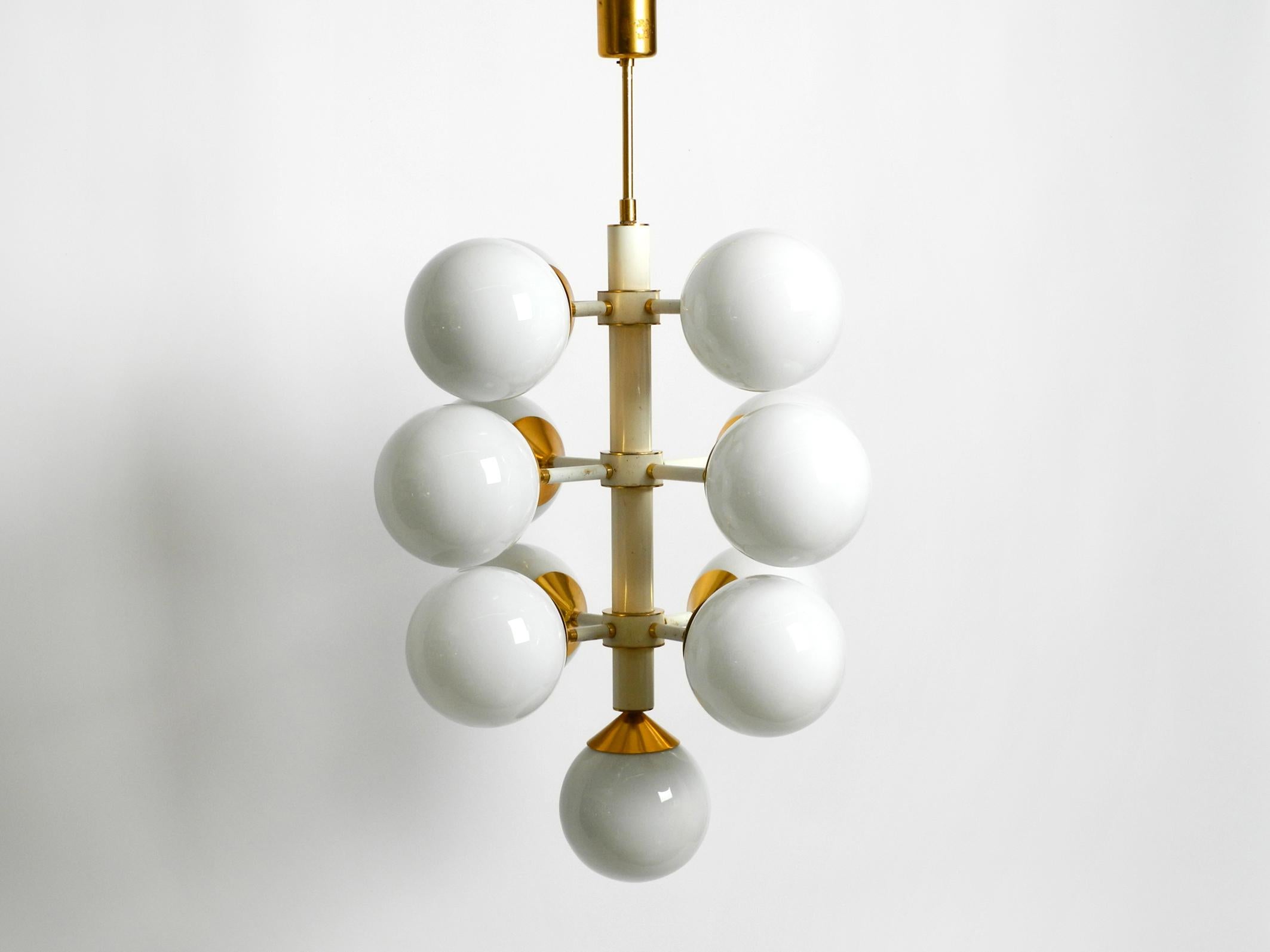 Beautiful rare large 1960's Space Age brass ceiling lamp with 13 white spherical glasses.
Frame is made entirely of metal.
The cups for the glass balls are made of brass with an anodized copper color.
Made in Germany. Great sixties Space Age