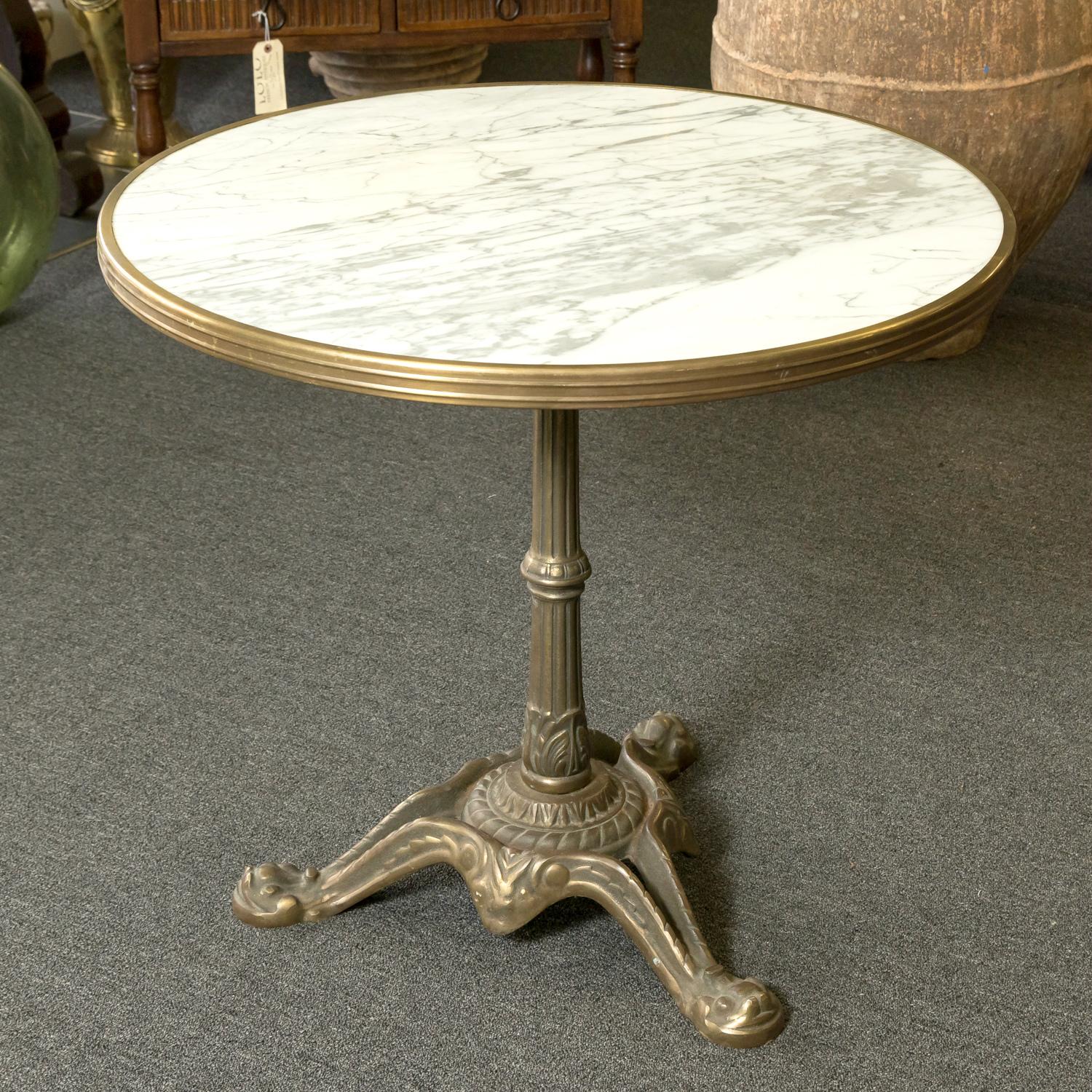 A beautiful and rare large 19th century French Parisian bistro or cafe table, having the original classic white marble top with brass surround, circa 1890s. Raised on a fluted bronze tripod base with an aged patina that only comes with age and