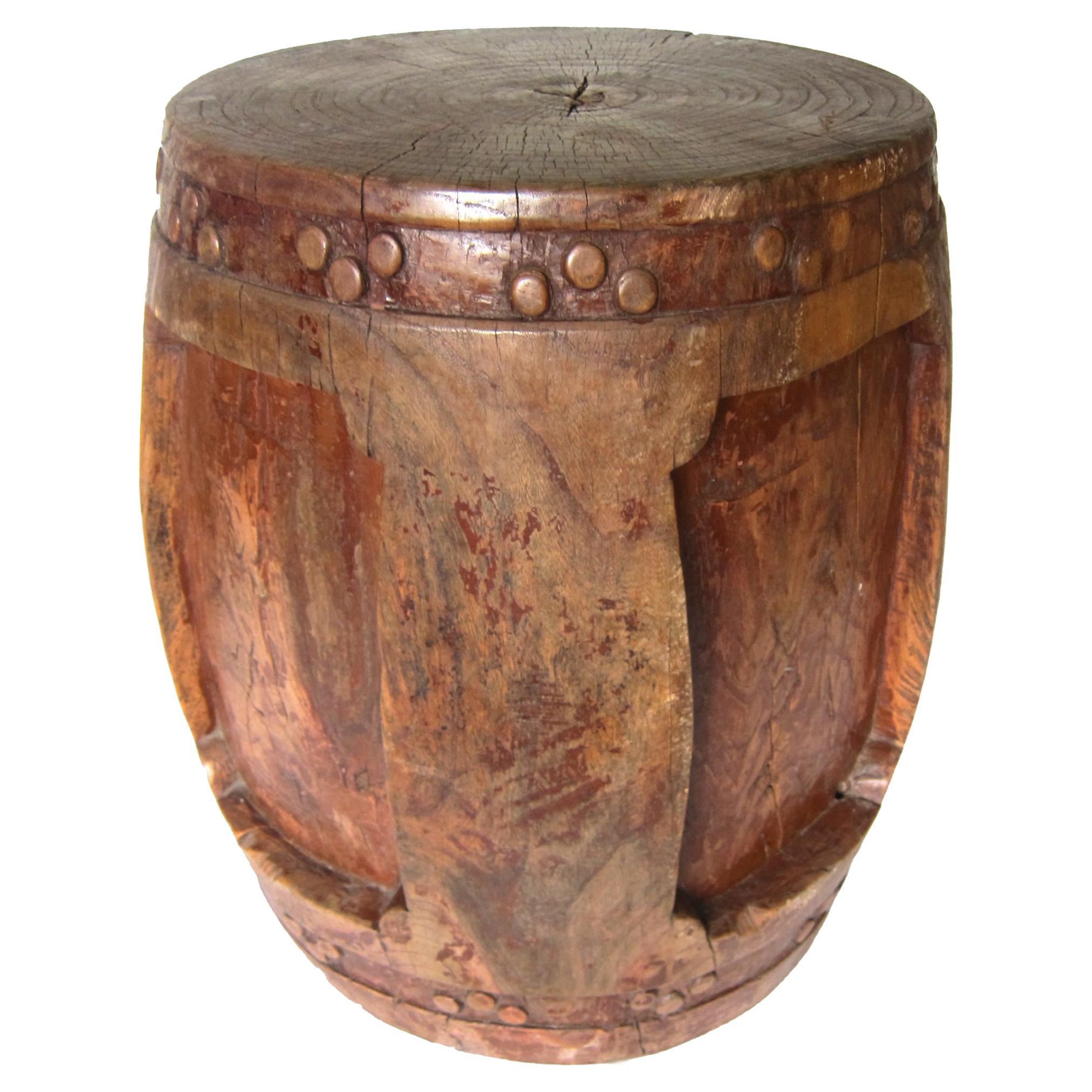 This unusual carved Chinese wooden stool is from the Qing dynasty (circa 1820). The stool is finely carved from the center of a northern elm (Yumu) tree trunk and into the traditional shape of a Chinese drum and porcelain garden stools. Great