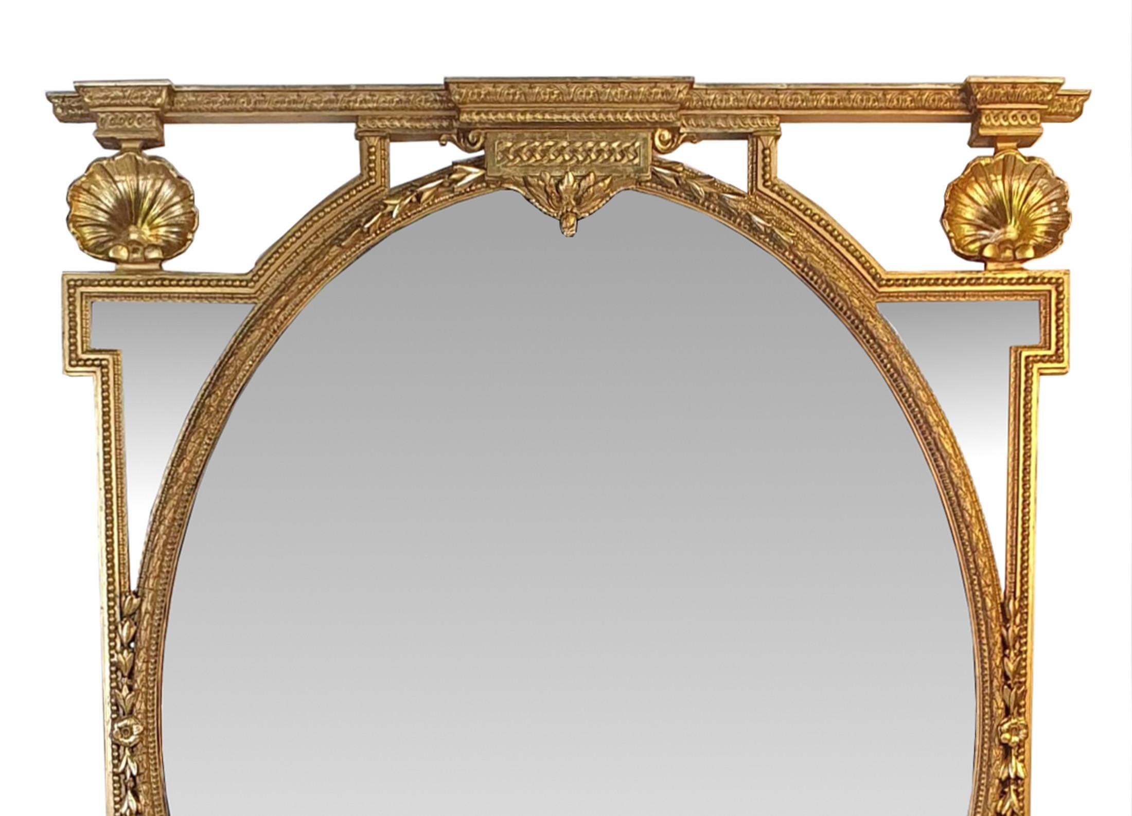 Rare grand miroir ovale en bois doré du XIXe siècle. Le cadre compartimenté en bois doré, étonnamment sculpté à la main, est orné de coquillages, de perles, de coques de cloches, de têtes de fleurs et de motifs feuillagés. 



 
