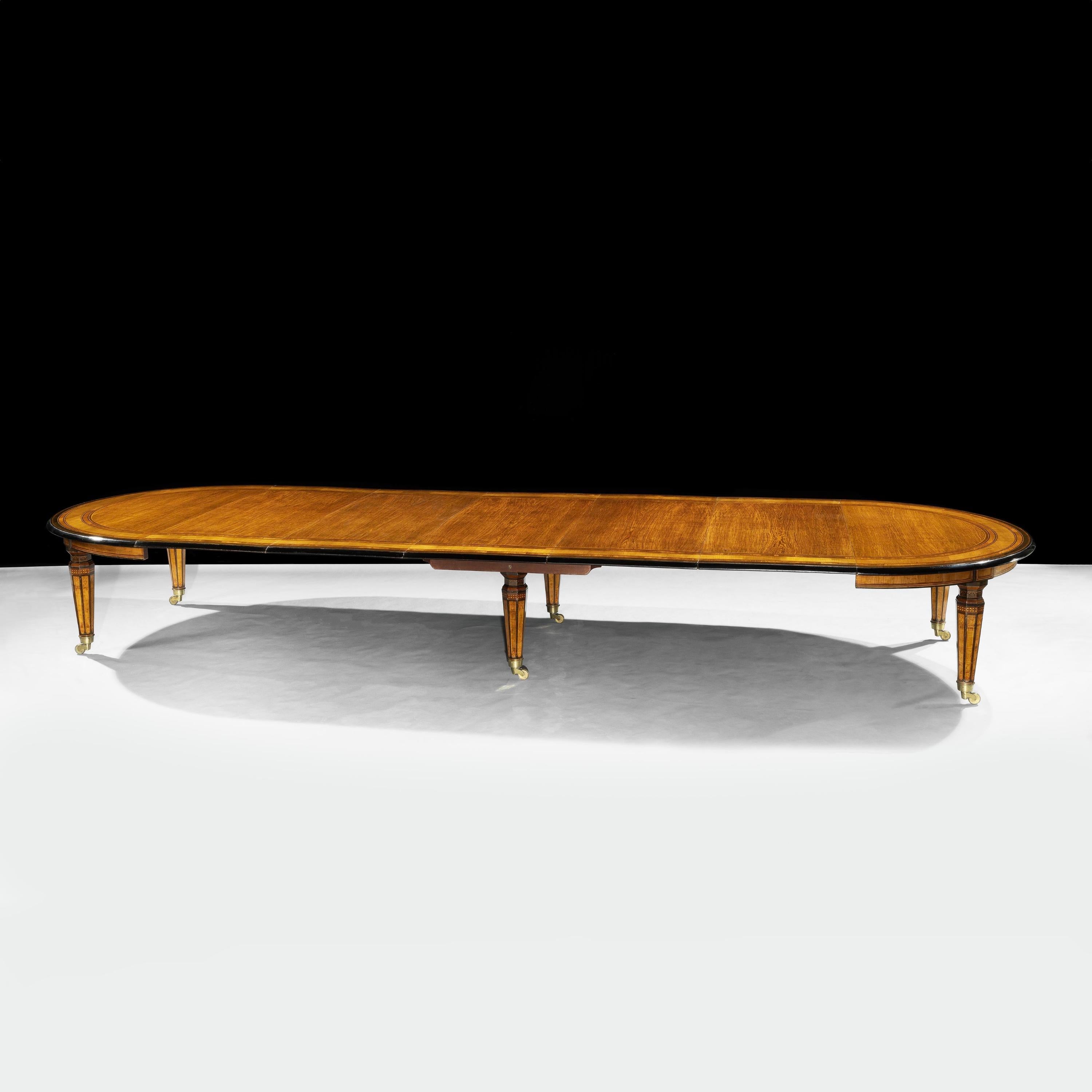 An Extraordinary Extending Dining Table
Attributed to Jackson & Graham

The circular top, which can be extended to accommodate from 8 to 22 guests by the addition of 5 leaves, all of oak, features a moulded ebonised edge and inlaid banded borders of
