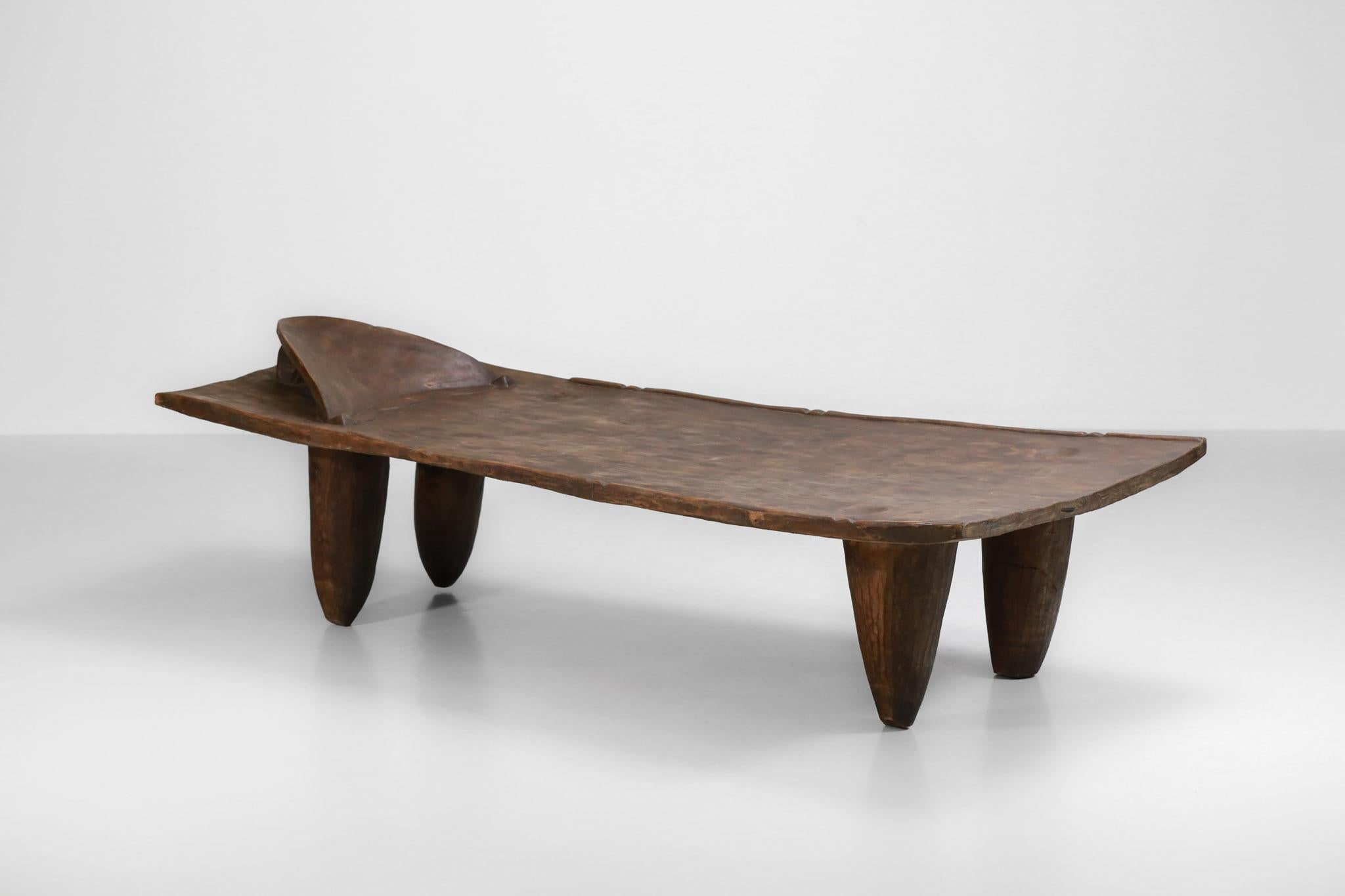 Large African resting bed made of solid wood from Benin which can also be used as a coffee table. 
Entirely hand carved in a single piece of wood.