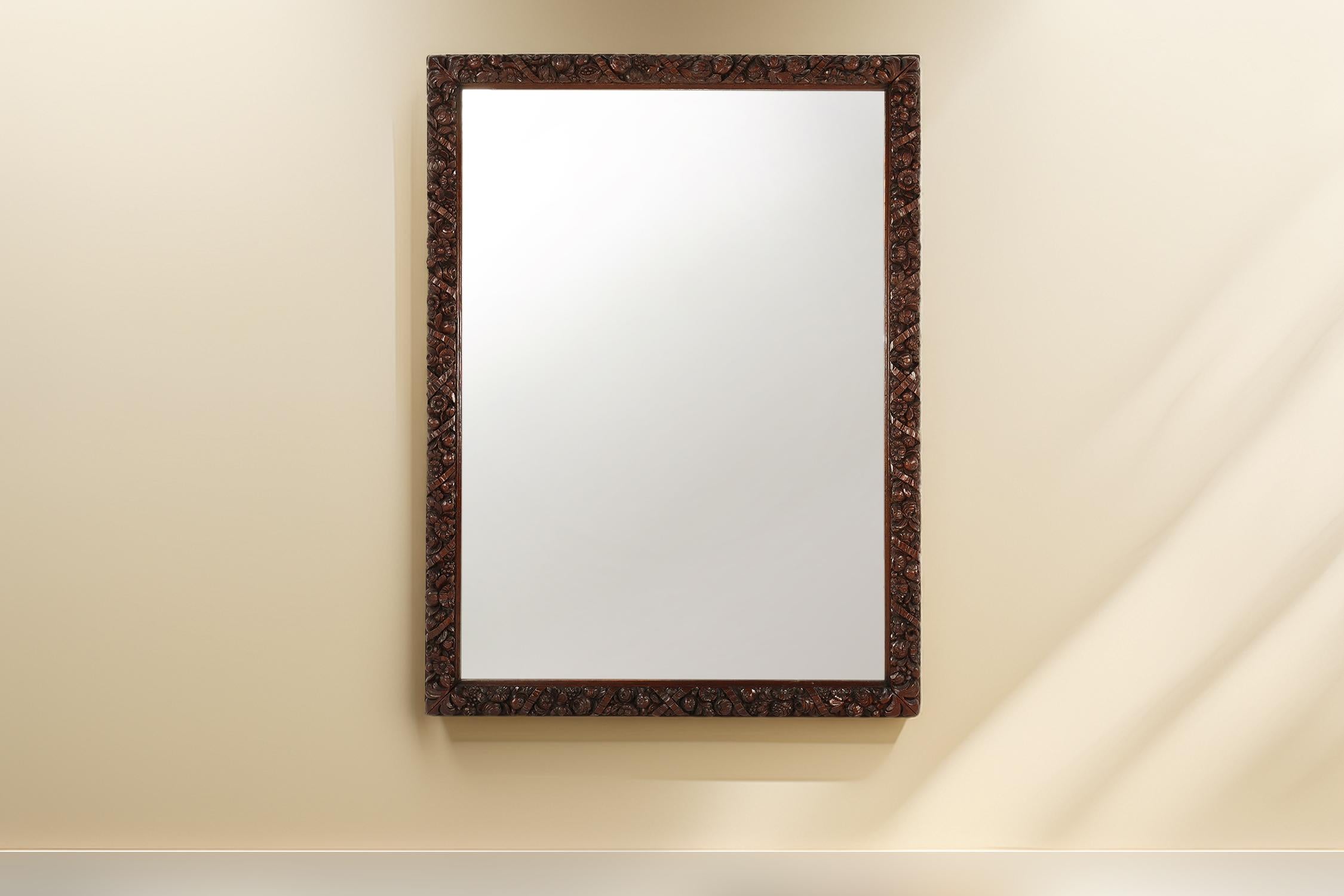 France  / 1800 / mirror / oak / Antique / Baroque / Rococo / Mid-century

Large monumental sculpted oak wall mirror, hand crafted around 1800 in France. This antique baroque style mirror has an oak wooden frame with luxurious flower carvings. This