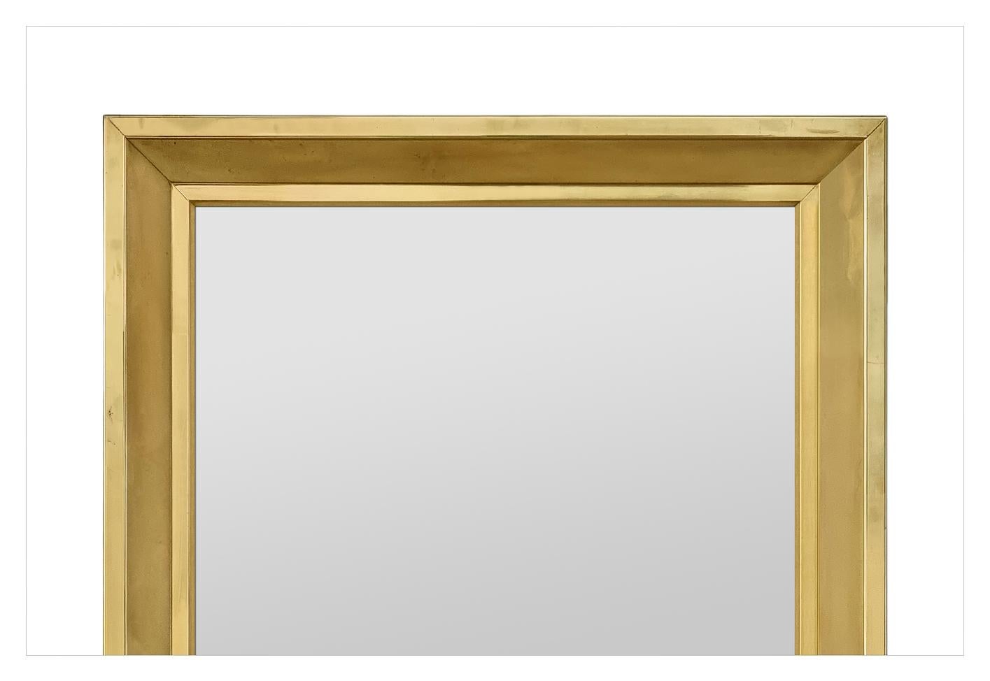 Large Antique French brass wall mirror from the 1970s. Rare brass frame folded over a molded sloped frame. Frame width: 7.5 cm /  2.95 in. Modern glass mirror. Wooden rear panels.