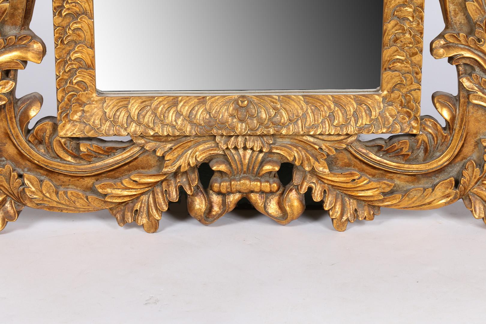 A rare large 20th-century English gilt wall mirror, having a scroll frame above a rectangular bevelled glass plate, 117cm by 84cm.
This mirror can be suitable as a console and pier mirror as well.