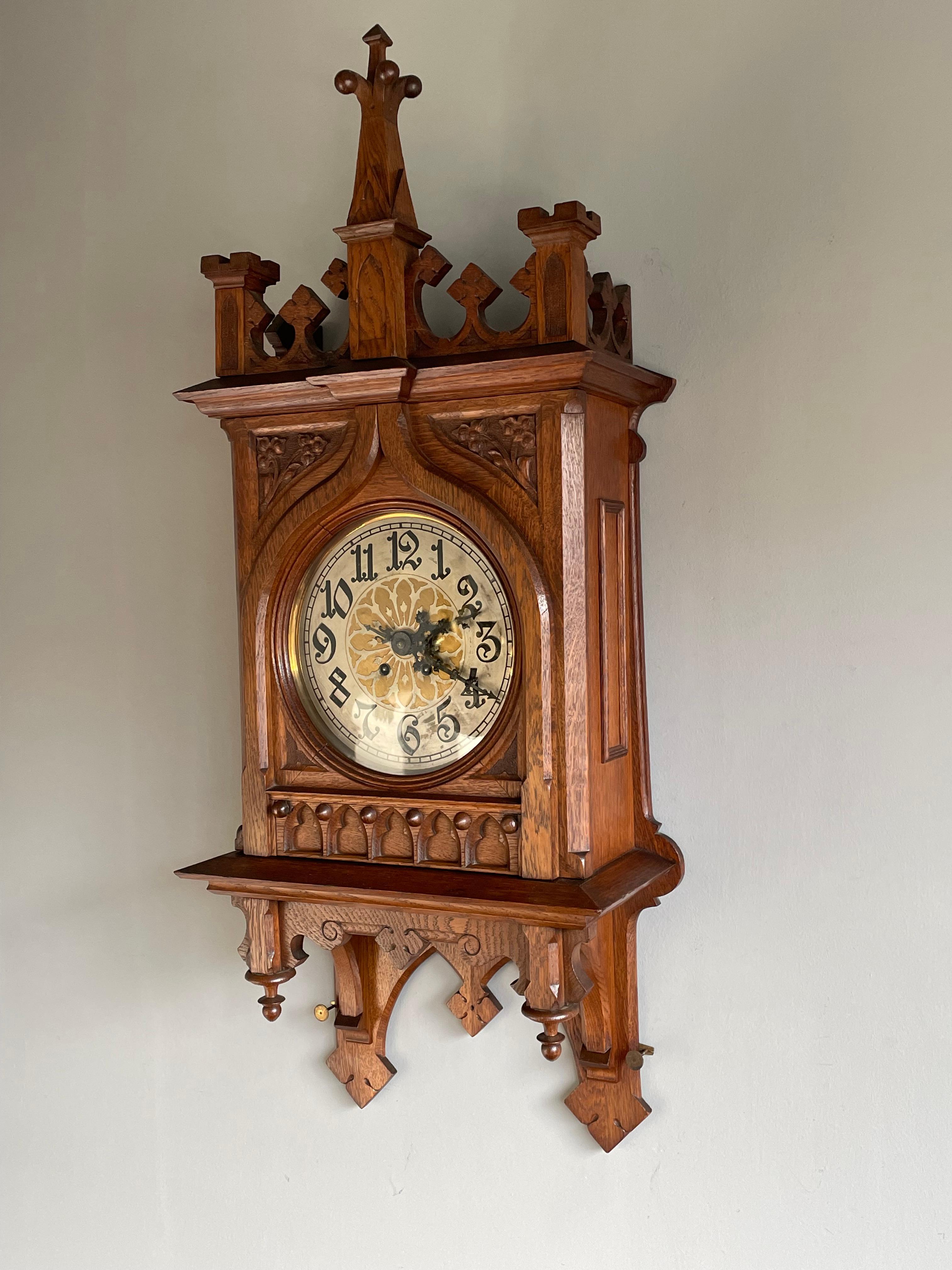 Large and impressive clock with an abundance of Gothic details.

Gothic wall clocks make great decorative antiques and this turn of the century specimen, in our view, has the perfect size and design to use and enjoy in any Gothic (inspired)
