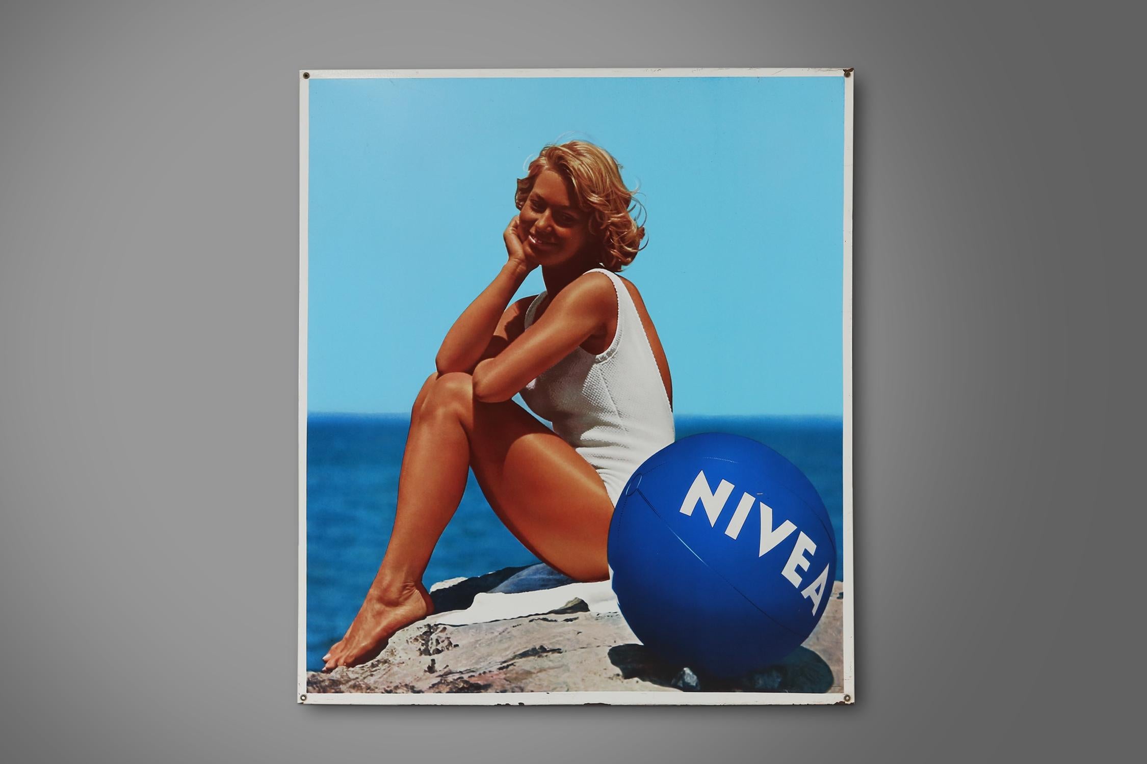 Belgium / 1970s / Nivea / advertising sign / mid-century / vintage / design

This rare to find large Belgian advertisement shows a woman on the beach, in front of her the famous blue Nivea beach ball. This stunning advertisement in attractive bright